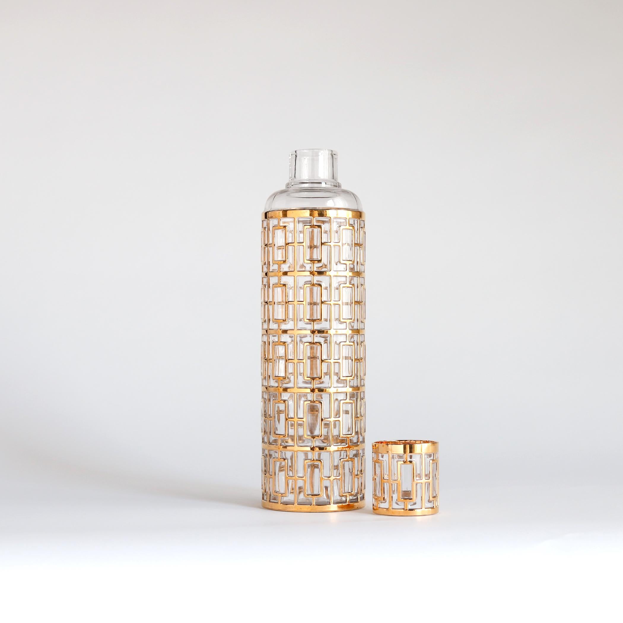 Sake decanter bottle in the Shoji pattern by Imperial Glass, 1960s or 1970s. The raised geometric pattern, detailed in gold, imitates the type of work found in Japanese screens. The top of this sake bottle (or 'saki' as Imperial spelled it) doubles