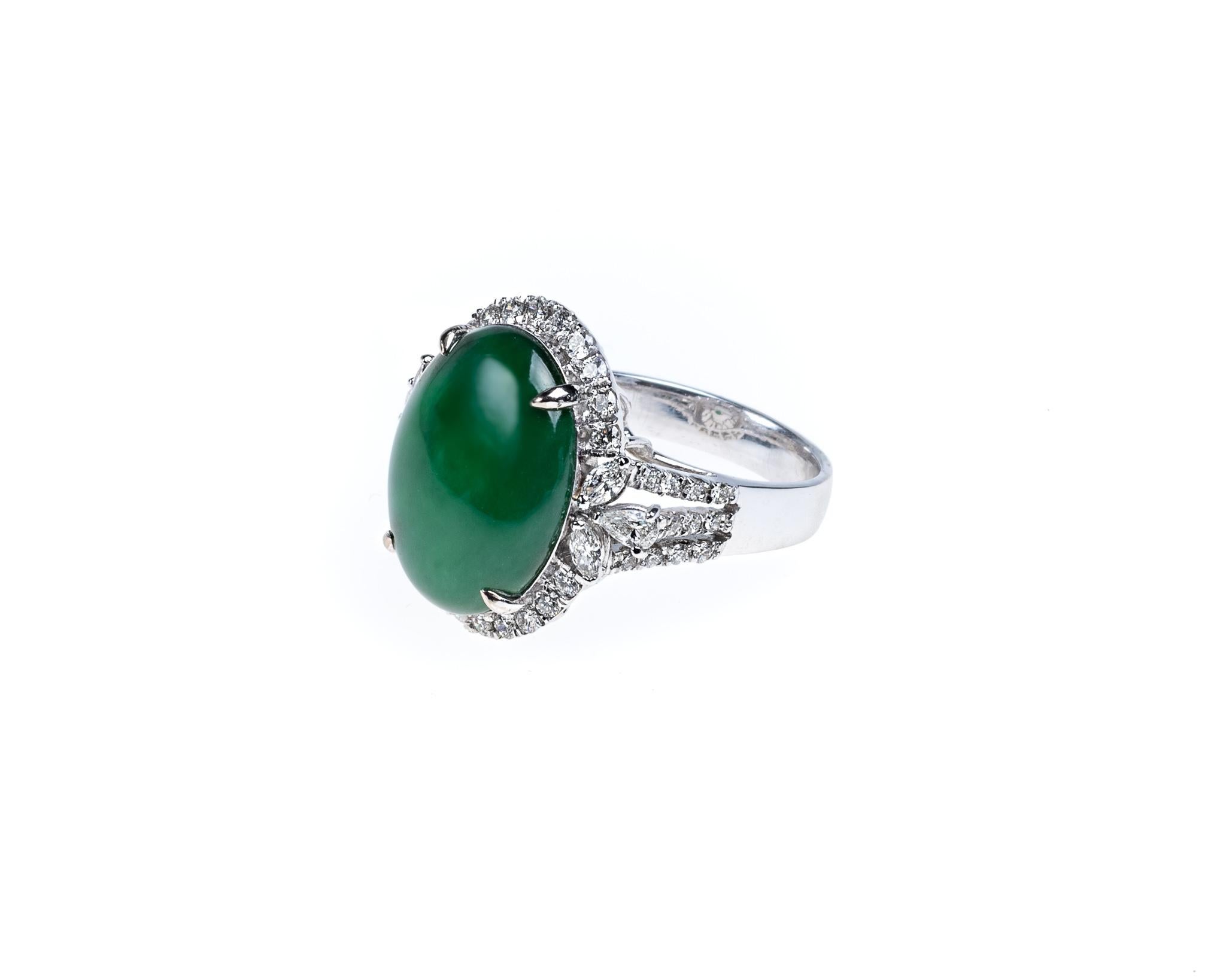 This all natural, untreated jadeite jade carved cabochon is set on an 18K white gold diamond ring setting featuring a halo setting with round brilliant, marquis and pear shaped diamonds with a total weight of 1 carat. 

The jadeite jade cabochon