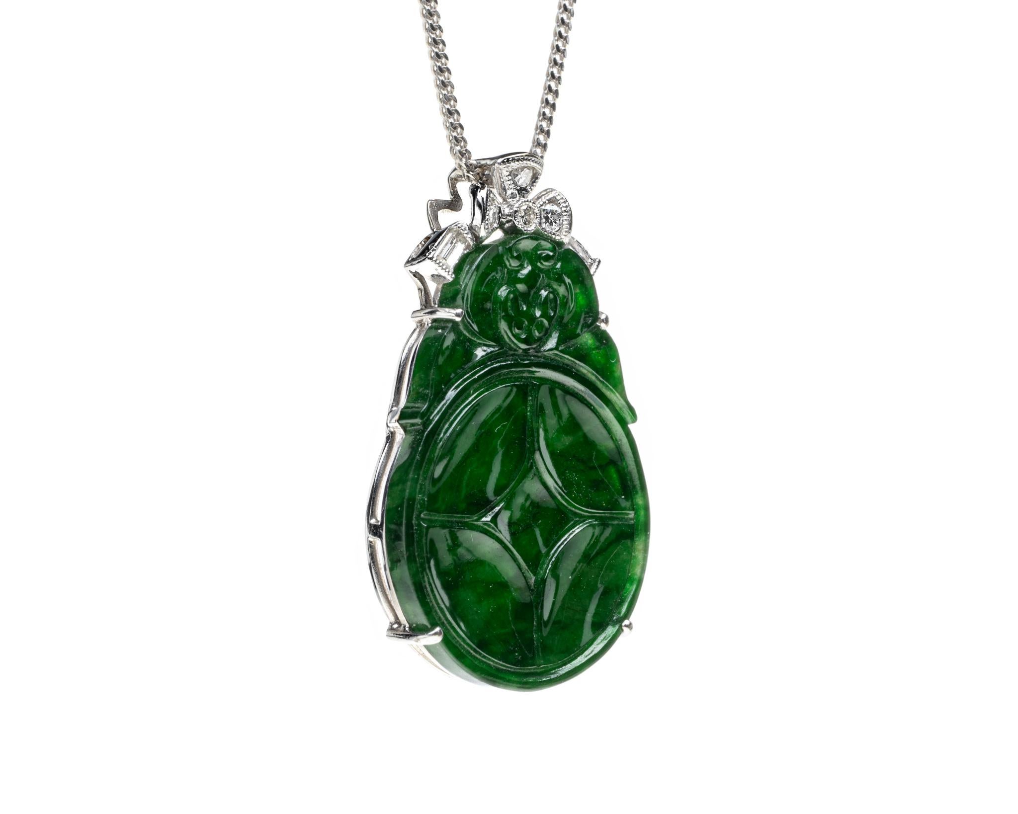 This is an all natural, untreated jadeite jade carved coin pendant set on an 18K white gold and diamond bail.  The carved coin symbolizes money, wealth and prosperity.
   
It measures 1.28 inches (32.5 mm) x 0.79 inches (20.2 mm) with thickness of