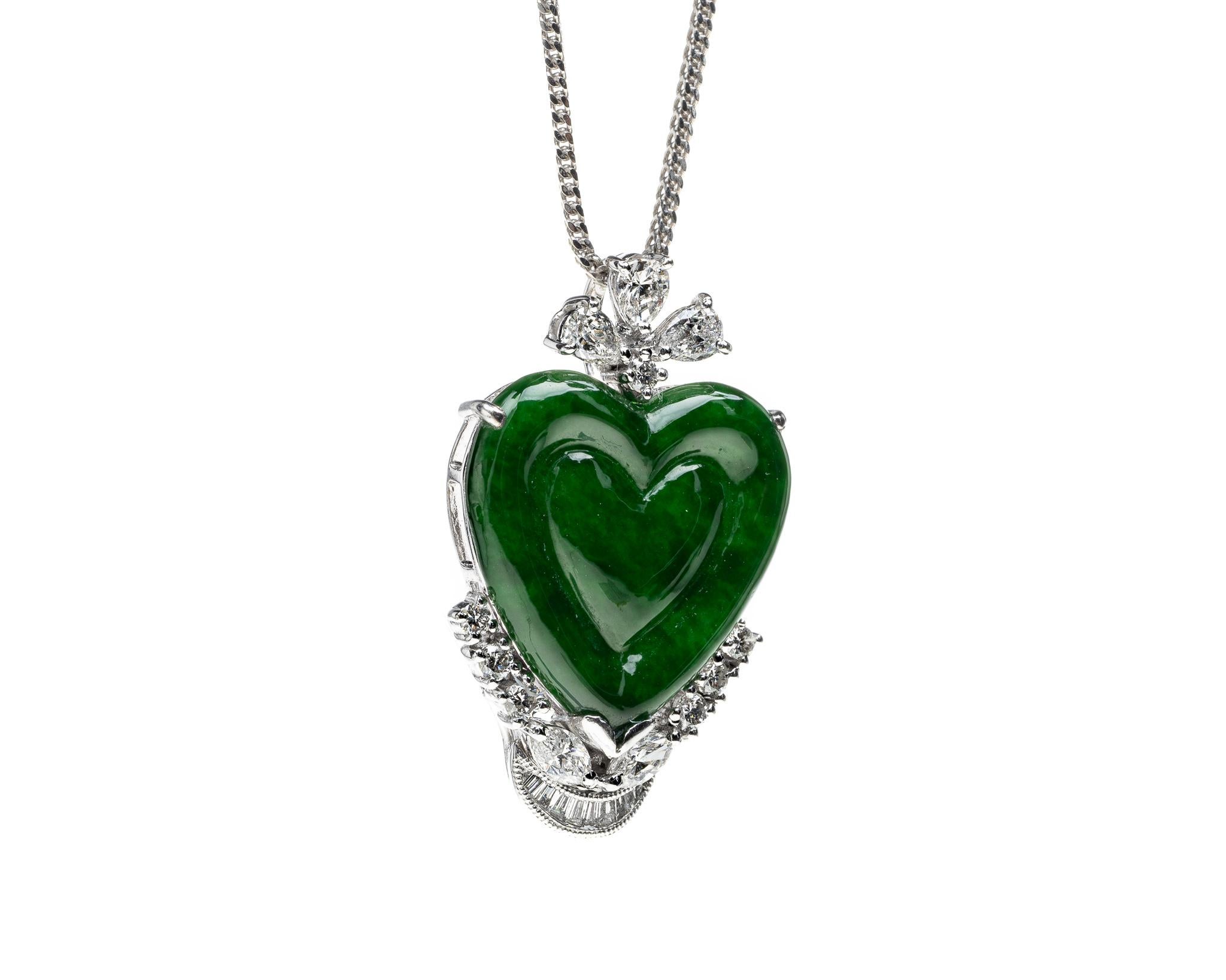 This is an all natural, untreated Imperial green jadeite jade carved heart.  It is set in an 18K white gold diamond setting with round brilliant, pear and tapered baguette diamonds totaling 0.51 carat weights.  The heart carving symbolizes love and