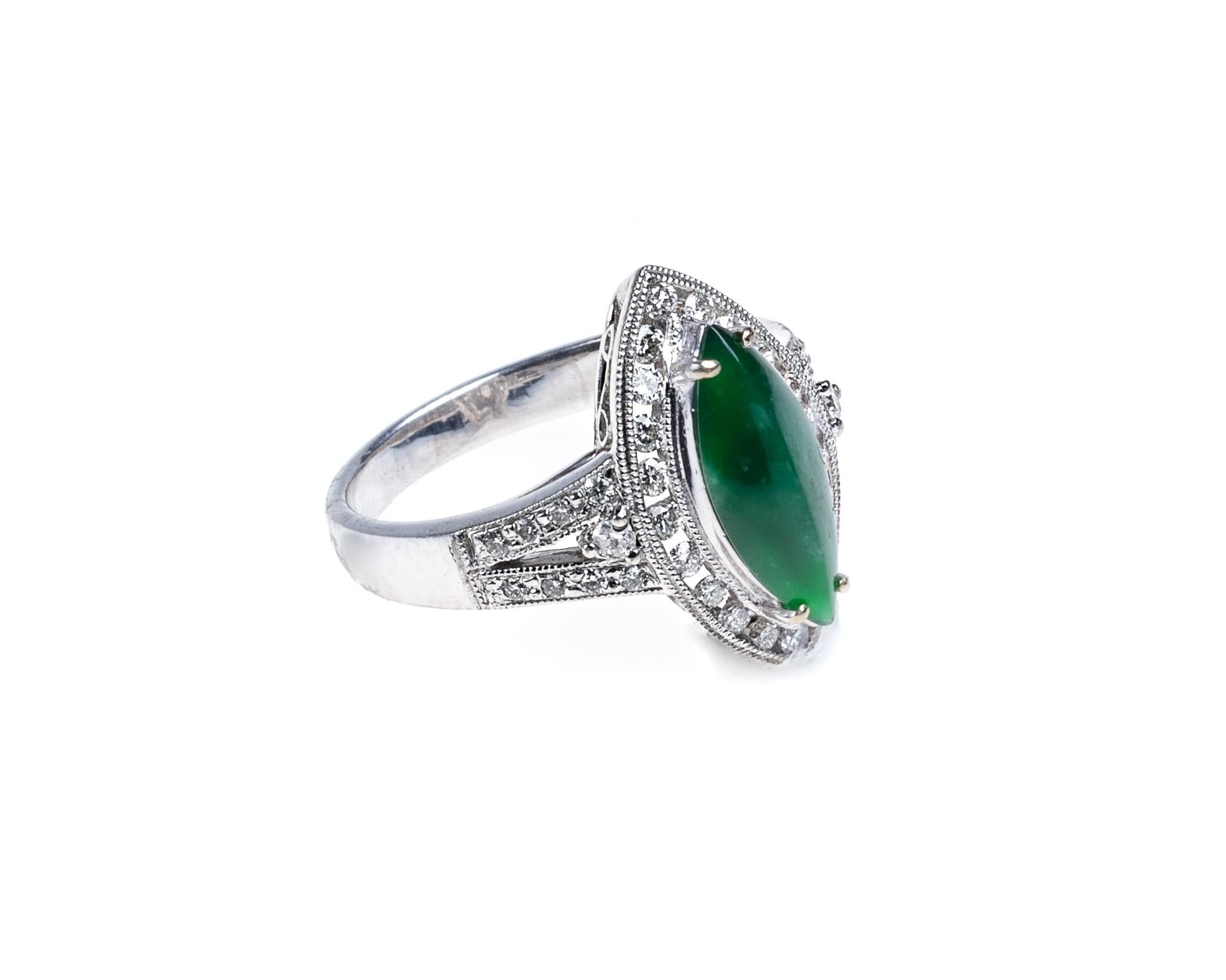 This all natural, untreated imperial jadeite jade marquise ring surrounded with round brilliant diamonds totaling 0.49 carats. 
Top of the marquise halo ring measure 0 .41 inches (10.5mm) x 0.70 inches (17.9mm) with thickness of 0.26 inches (6.8mm)