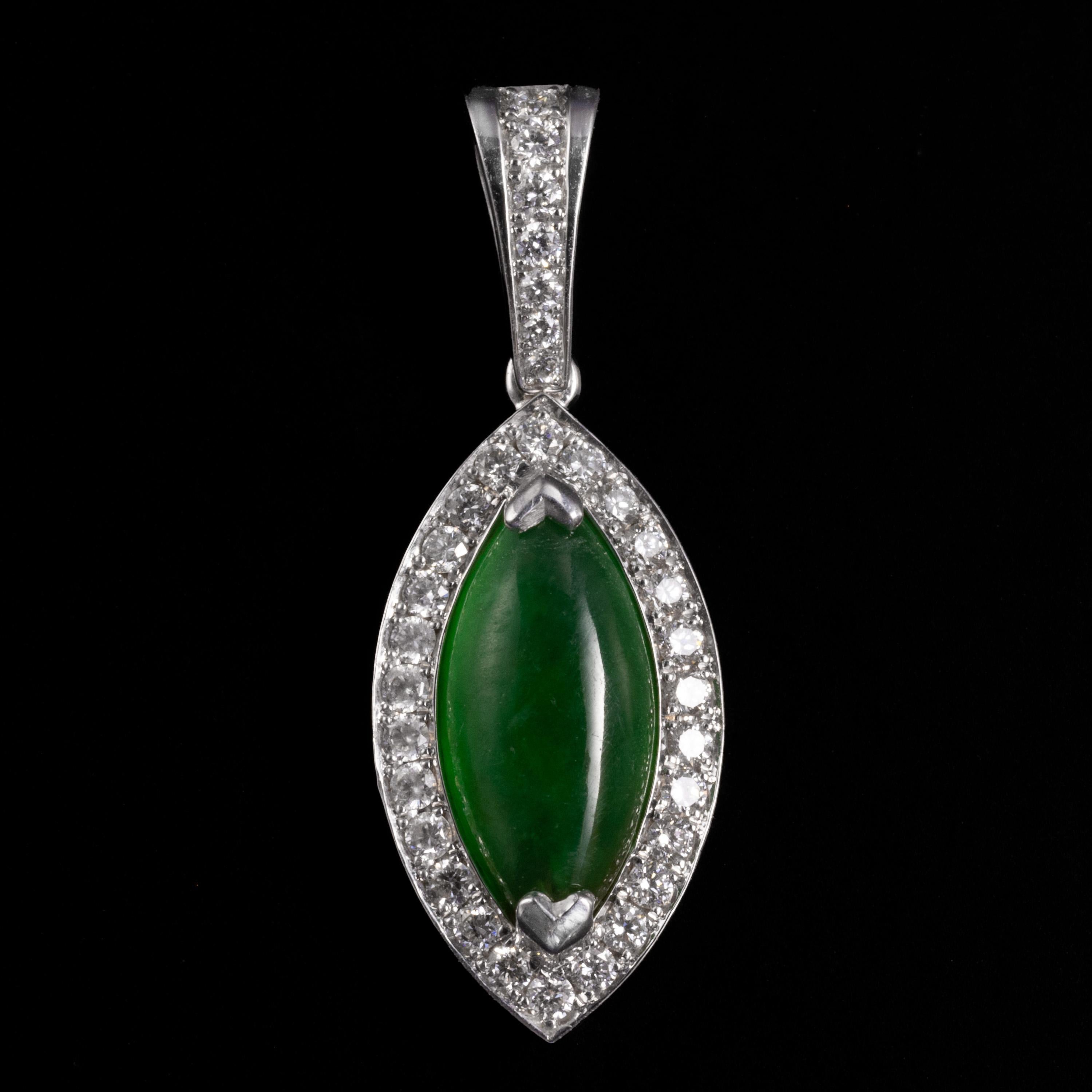 This imperial jade & diamond pendant is simple and perfect.

The mid-century (circa 1960s-1970s) pendant has been rendered in 18K white gold and set with a quarter-carat of small, bright round diamonds that do their job perfectly: they frame the