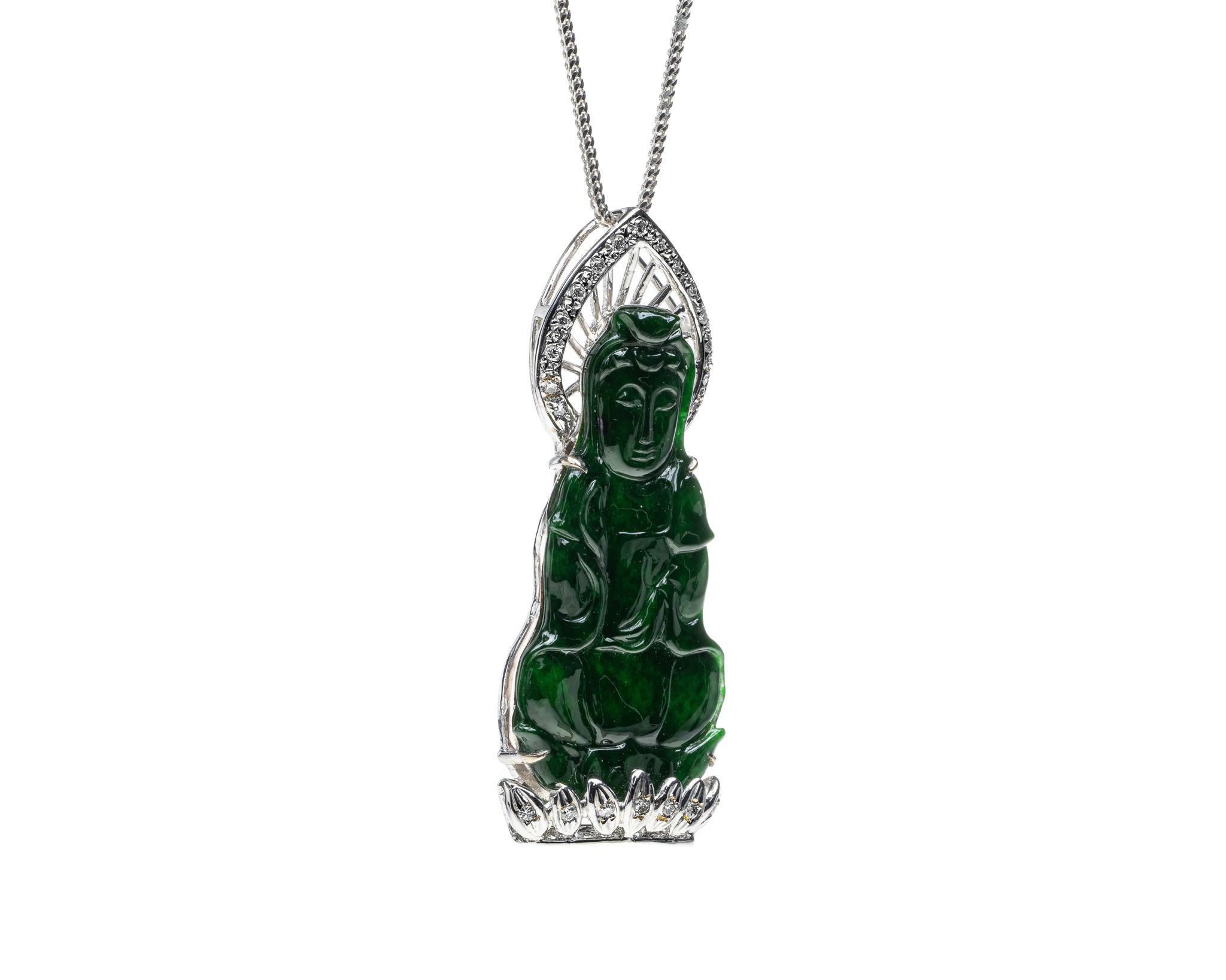 This is an all natural, untreated green jadeite jade carved Quan Yin god pendant set on an 18K white gold bail.  The carved Quan Yin god symbolizes compassion and protection. 

It measures 1.86  inches (47.3 mm) x 0.79 inches (20.2 mm) with