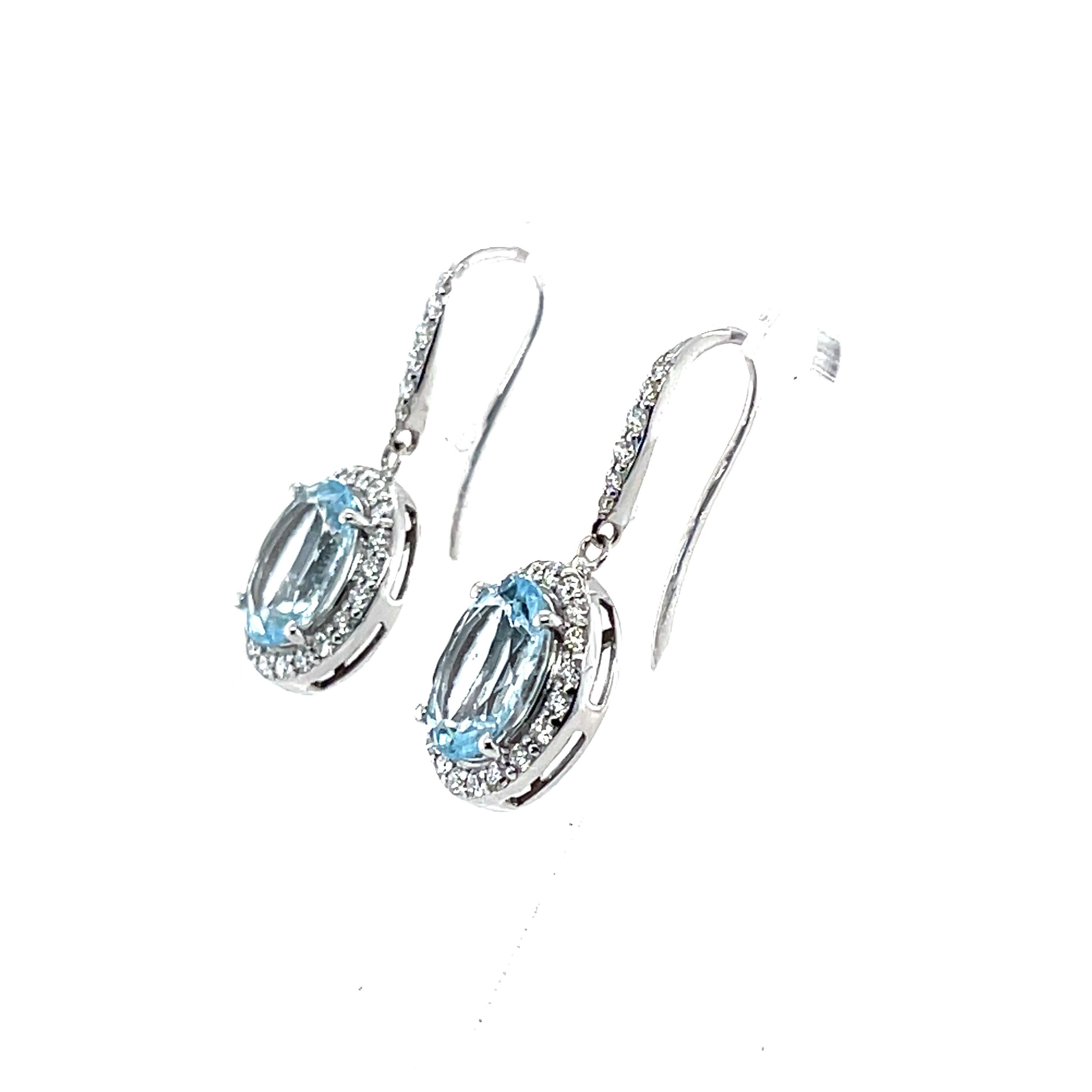 A Stunning pair of 14CT white gold oval cut Aquamarine and round brilliant cut diamonds on a beautifully crafted shepherds hook earrings. 

Aquamarine Weight: 3.76ct
Aquamarine Colour: 