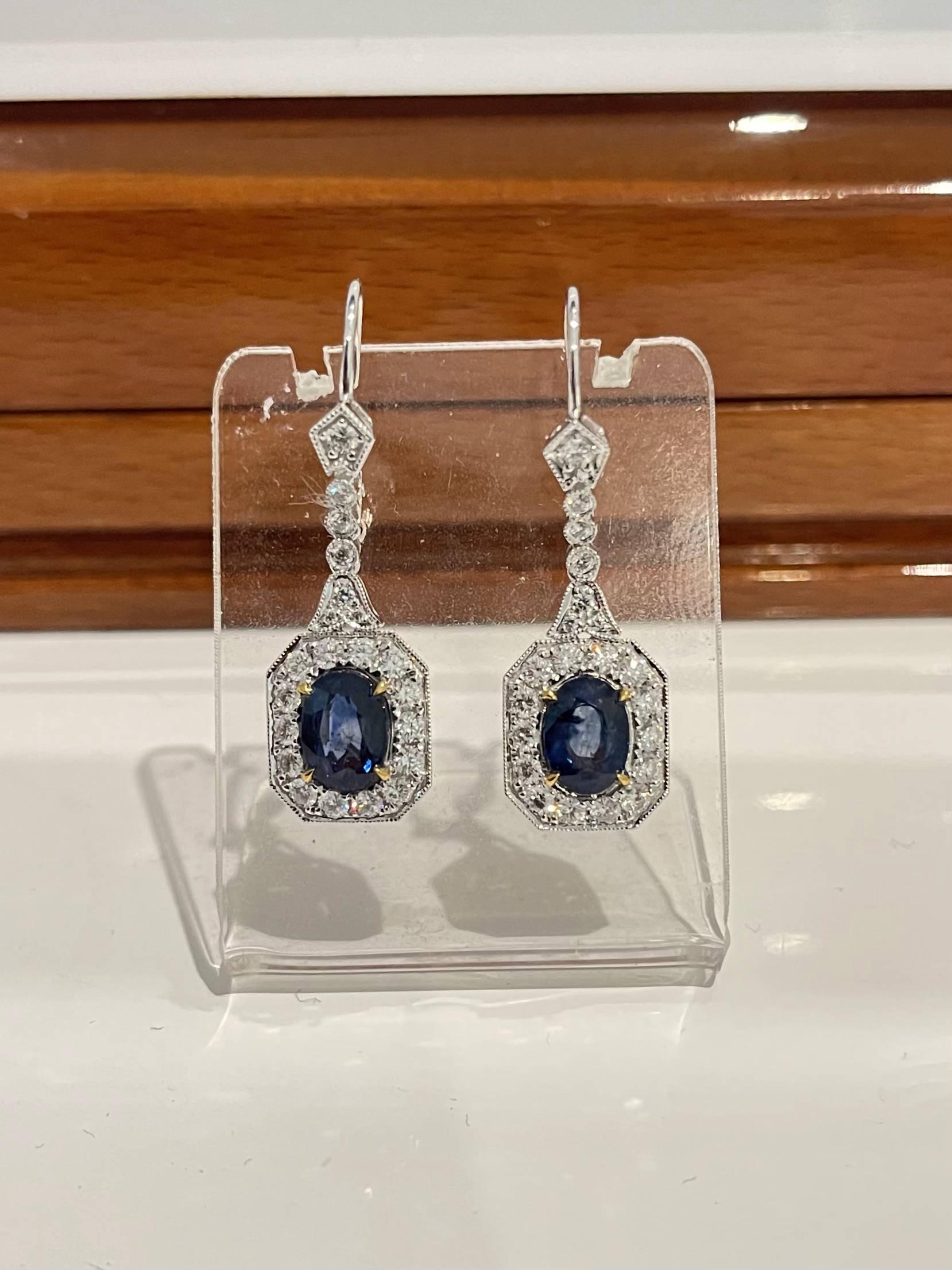 Oval shaped Sapphires, crafted with fourteen karat white gold, featuring a stunning selection of forty-two claw and rub over set round brilliant cut diamonds, complemented by a polished finish design. 

Sapphire Weight: 2.75ct
Sapphire Colour: