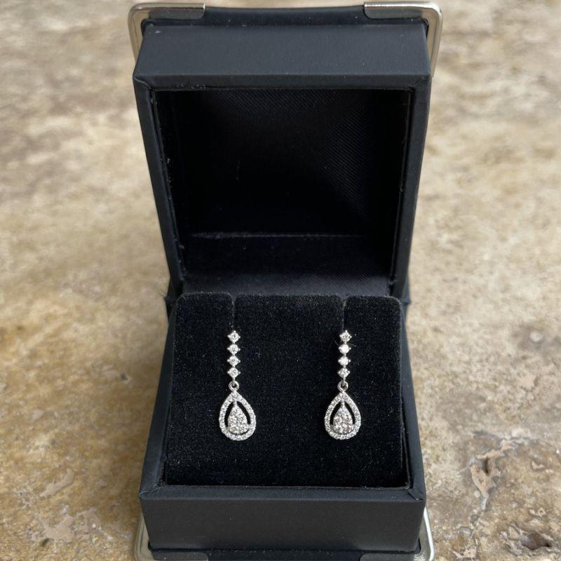 Diamonds, crafted with eighteen karat white gold, featuring a stunning set of round brilliant cut diamonds, complemented by a stunning polished finish.