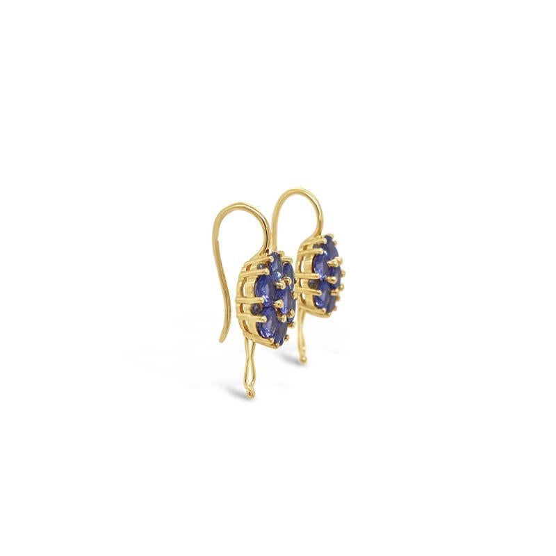 Tanzanite, crafted with eighteen karat yellow gold, featuring an elegant set of twelve rub over set round brilliant cut diamonds, complemented by a stunning polished finish design. 

Tanzanite Item Weight: 3.02ct
Tanzanite Colour: