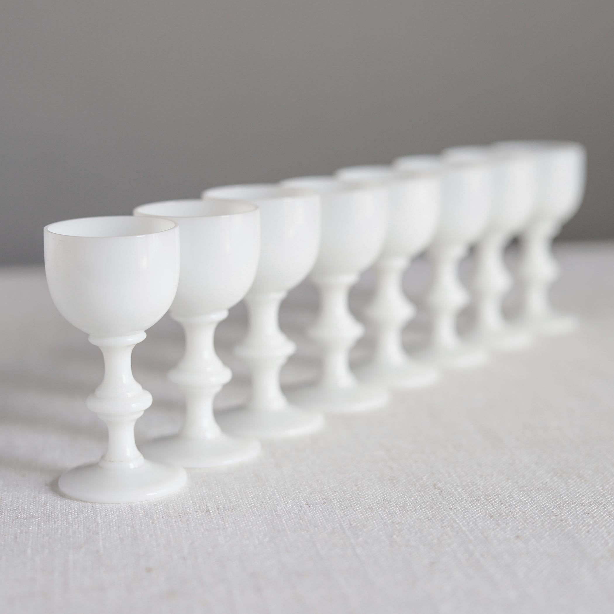 White glass decanter and eight cordial glasses by French manufacturer Portieux Vallerysthal. These glasses are very small, for just a small amount of after-dinner cordial. 

The decanter measures about 11 1/2 inches high, each cordial glass is 3 3/8