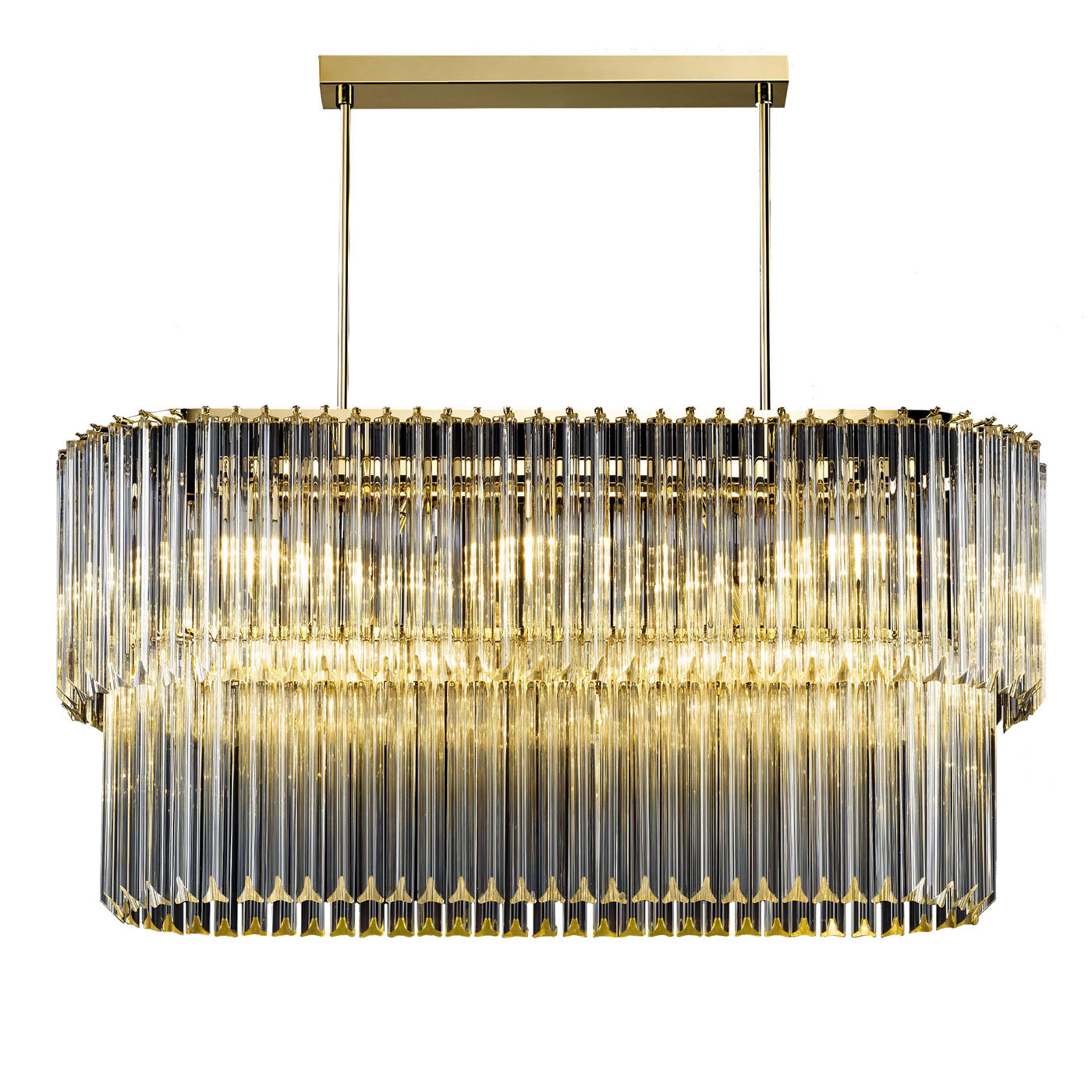 Bold and stately, this chandelier will illuminate a modern interior with utmost elegance. Clean and sophisticated with an oval profile, it features two layers of transparent glass trihedrons, mounted on a burnished metal structure. Emitting a warm