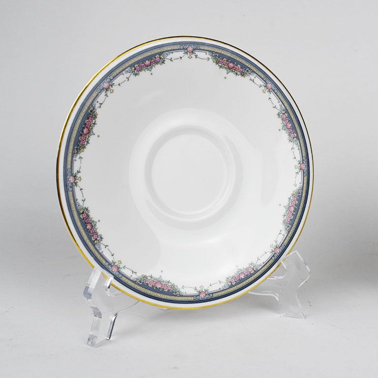 A beautiful Royal Doulton bone china saucer. This item is the Salisbury pattern and has been discontinued. With a gold rim, accented with delicate panted bouquets of flowers, and a nice crisp white center. A gold Greek key style design is accented