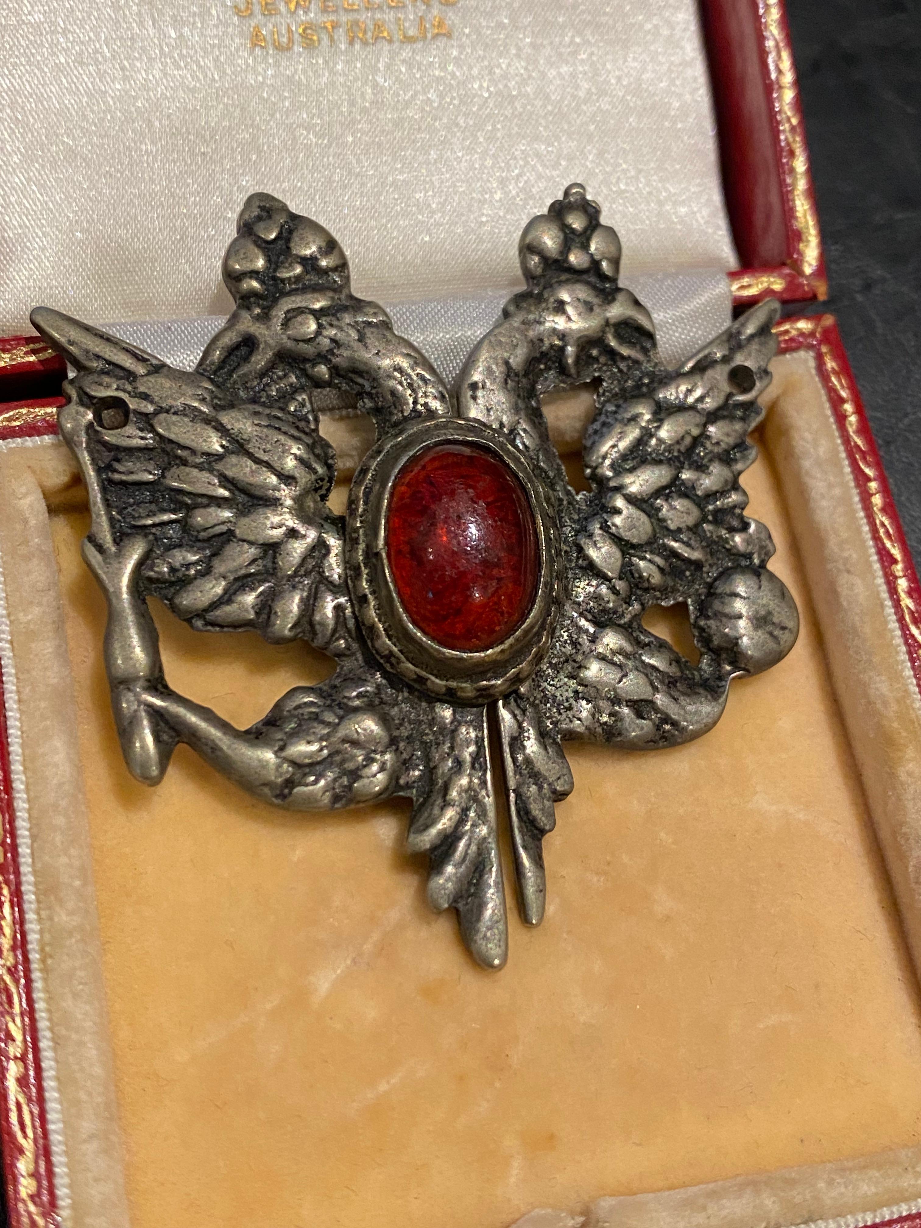 Finds such as these are incredibly rare

This belt buckle is crafted from silver metal, 
Featuring double headed eagle
with red glass to be centre 

Dimensions: 57mm x 53mm 

Circa 1900’s WWI 