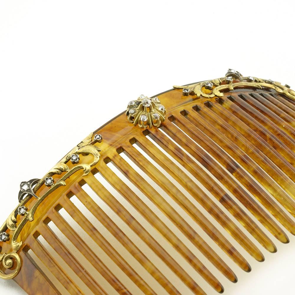 A Fabergé gold and diamond-set tortoise shell hair comb, workmaster Eduard Schramm, Saint Petersburg, circa 1900. The carved shell hair comb mounted with finely chased scrolling gold ornament set with rose-cut diamonds. Struck with workmaster's