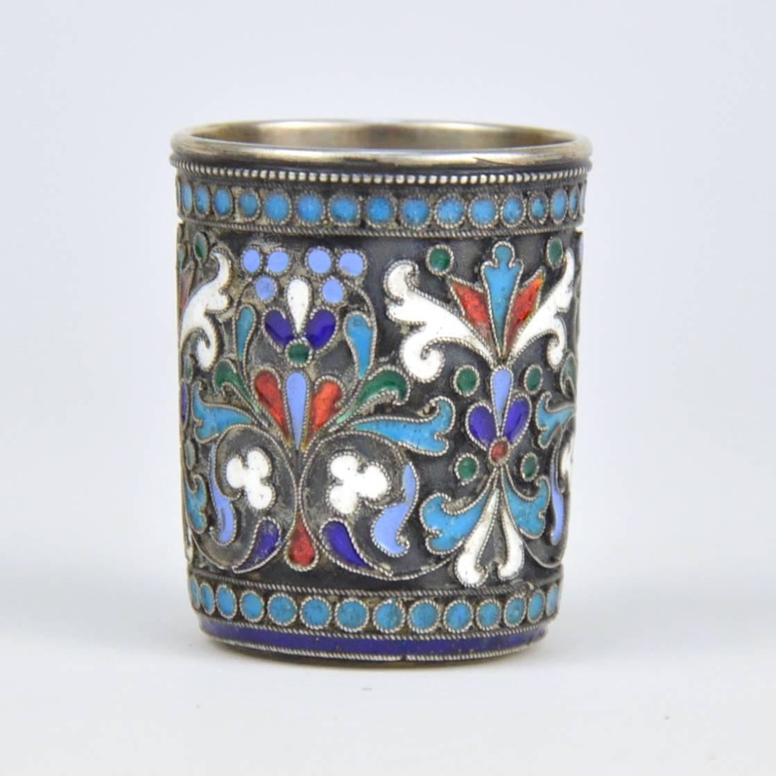 Imperial Russian cloisonné enamel and silver beaker. Finely hand decorated with a multi-color enamel scrolling foliage, flowers and pan-slavic ornamentation against a stippled background. Hallmarked with '84' Imperial Russian Silver standard and