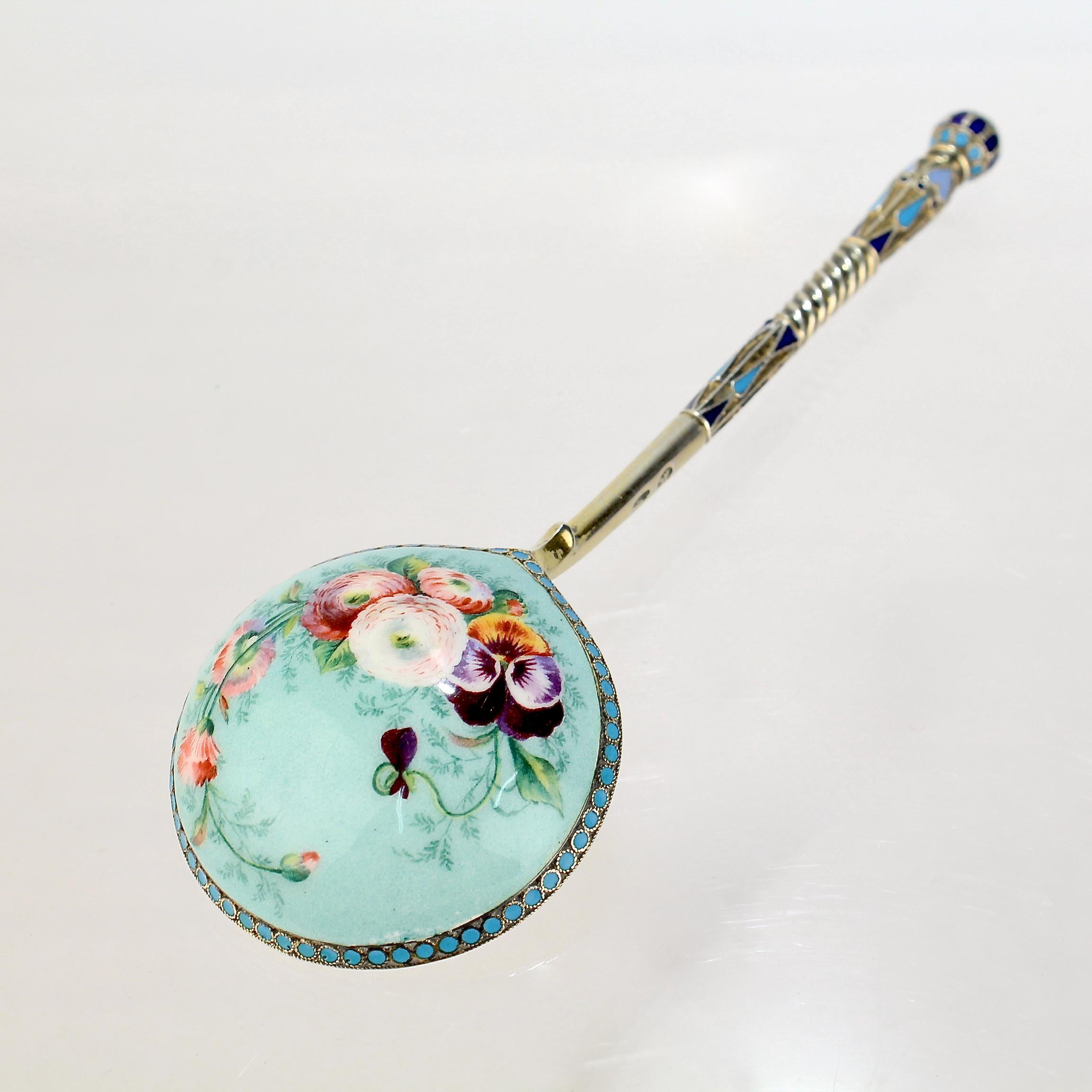 A very fine Russian silver & enamel spoon.

By Ivan Saltykov.

With a polychrome cloisonné enamel decorated handle and a hand painted pictorial flower scene on the reverse of the bowl. 

The bowl and handle of the spoon retain much of the original