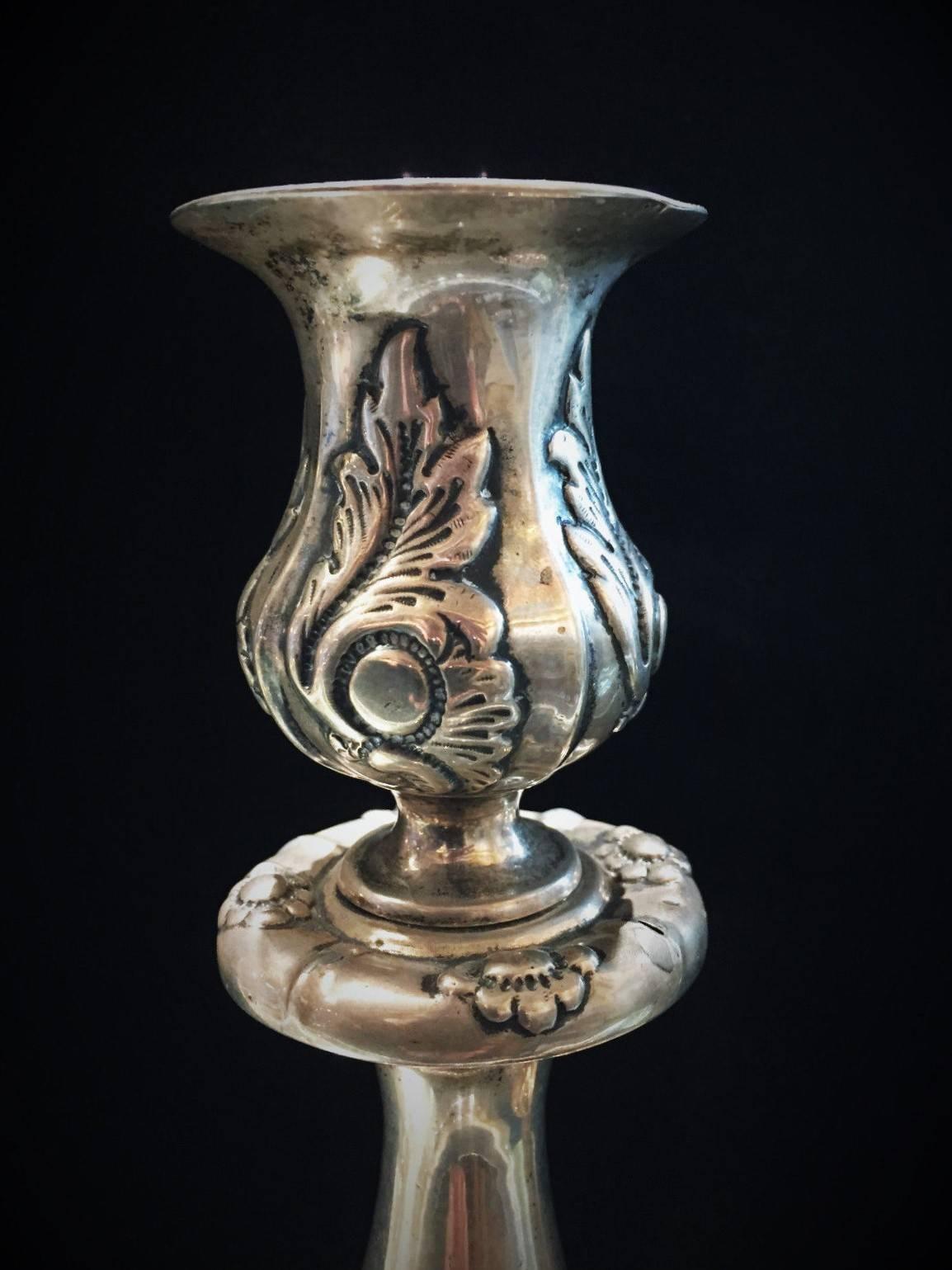 The scroll and floral decorations covering the base, stem and candle cup are finely crafted in the repoussé and chasing techniques.

Weight of each candlestick: 14.43 oz. / 461 g

Both candlesticks are fully hallmarked:
• 84° Russian silver