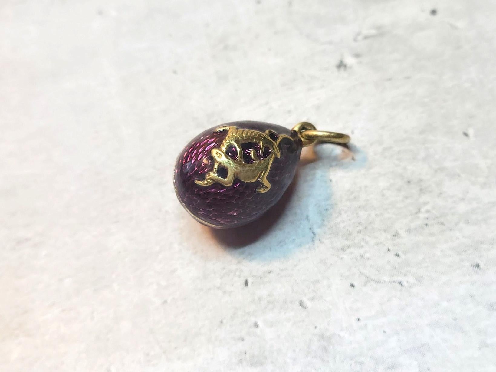 Presenting a stunning pendant designed in the shape of a Russian Imperial gilt silver and enamel egg with lizards. The body of the egg is enameled in a beautiful deep purple guilloche enamel. The use of different materials also adds to the charm of