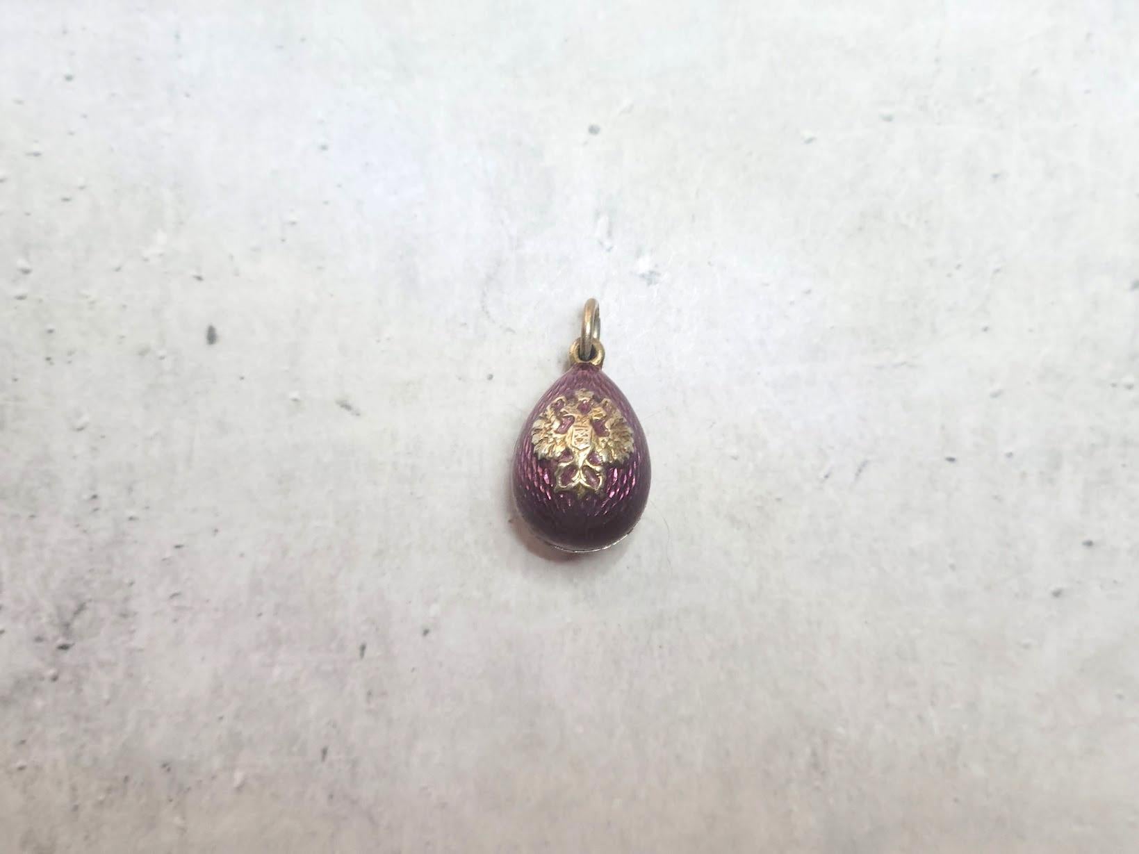 Presenting a lovely pendant designed in the shape of a Russian Imperial gilt silver and enamel egg with the two-headed eagle, the coat of arms of the Russian Empire. The body of the egg is enameled in a beautiful deep purple guilloche enamel. The