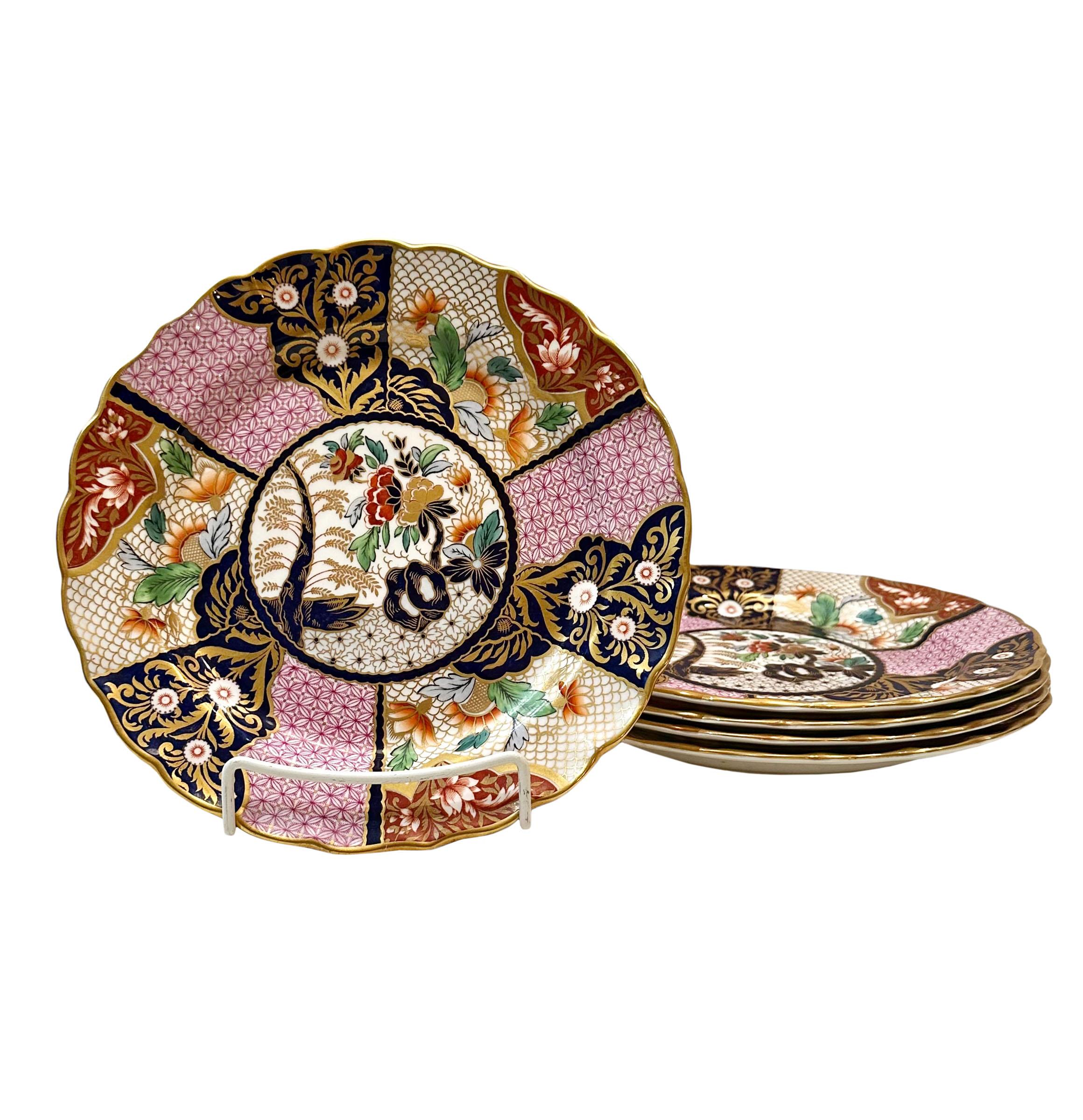 A set of four Imperial Stone china plates by John Ridgeway. Highly decorated in pink, gold and black with paneled with florals. English, 1835.