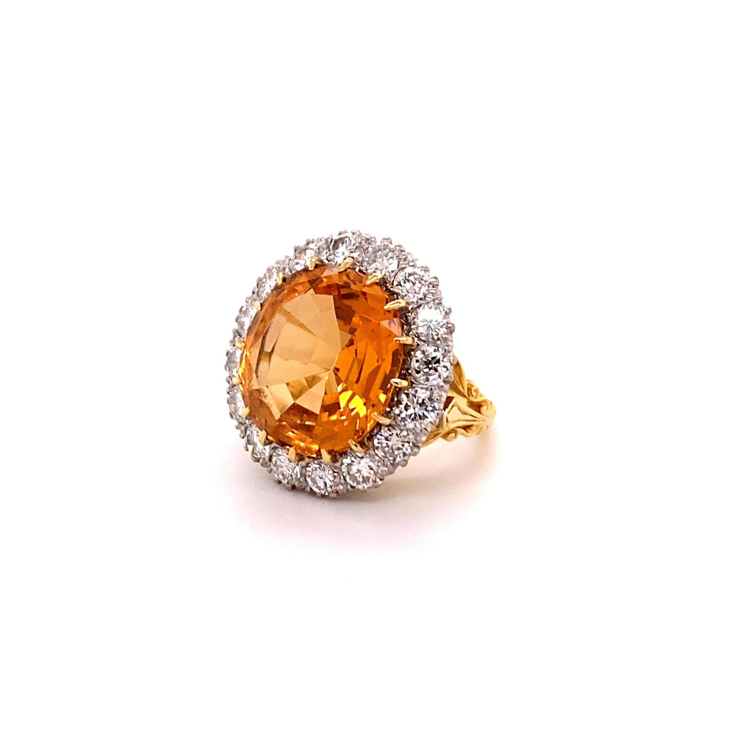 This sparkling cocktail ring features a cushion-shaped imperial topaz of approximately 14.00 carats. Surrounded by an impressive entourage of 16 brilliant-cut diamonds of G/H colour and si clarity, total weight approximately 2.40 carats.
The setting