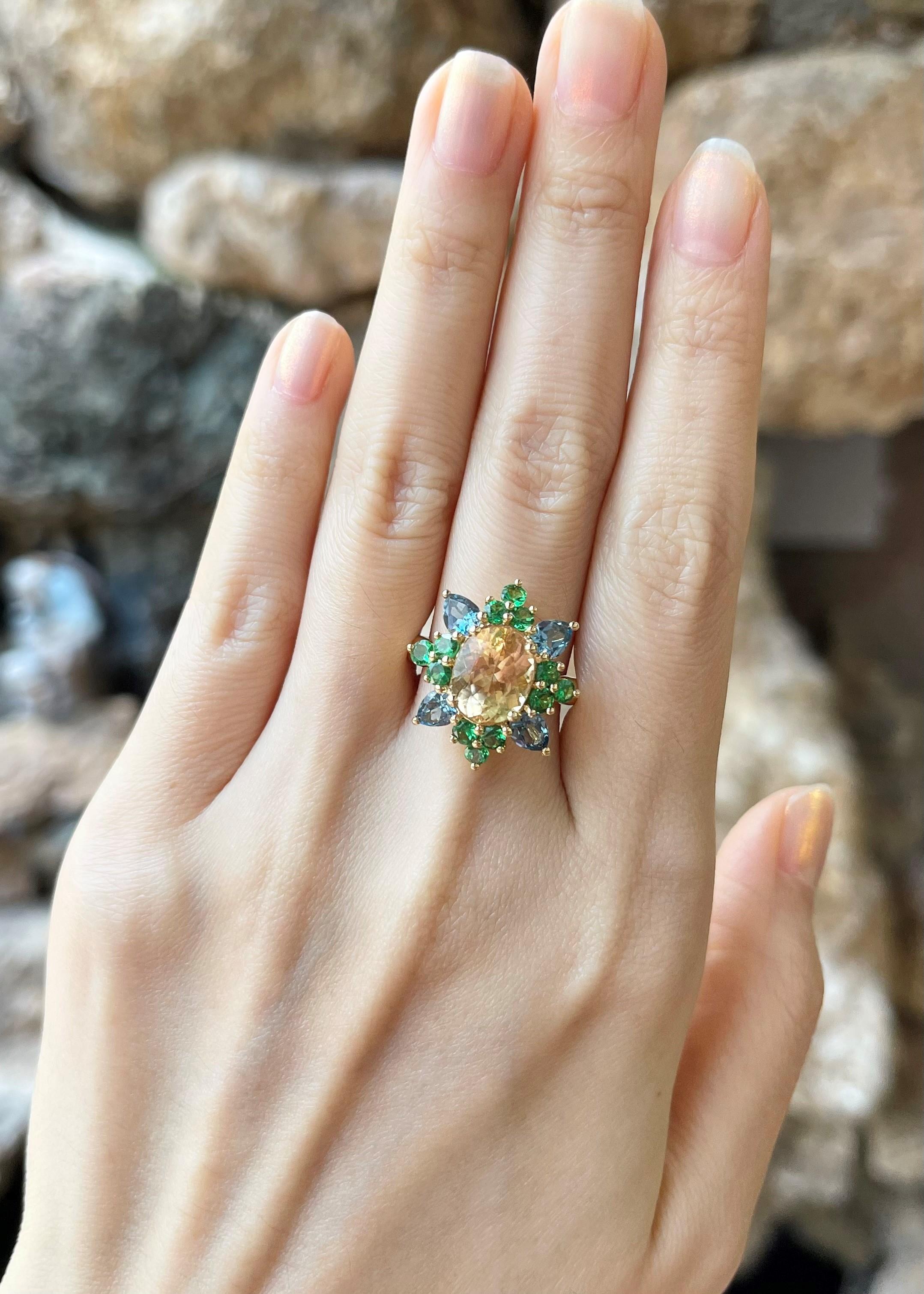 Contemporary Imperial Topaz, Aquamarine and Tsavorite Ring set in 18K Gold Settings For Sale