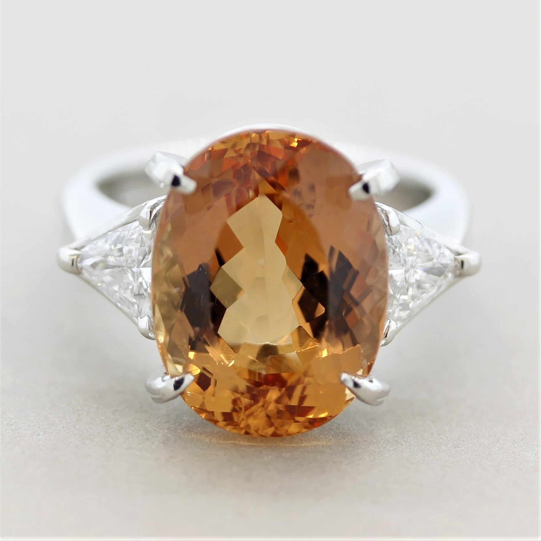 A superb crimson orangy-red topaz considered “imperial” in the trade due to its fine color. It weighs 10.86 carats and was expertly cut and polished as the stone has amazing brilliance and scintillation allowing for maximum light return. Accenting