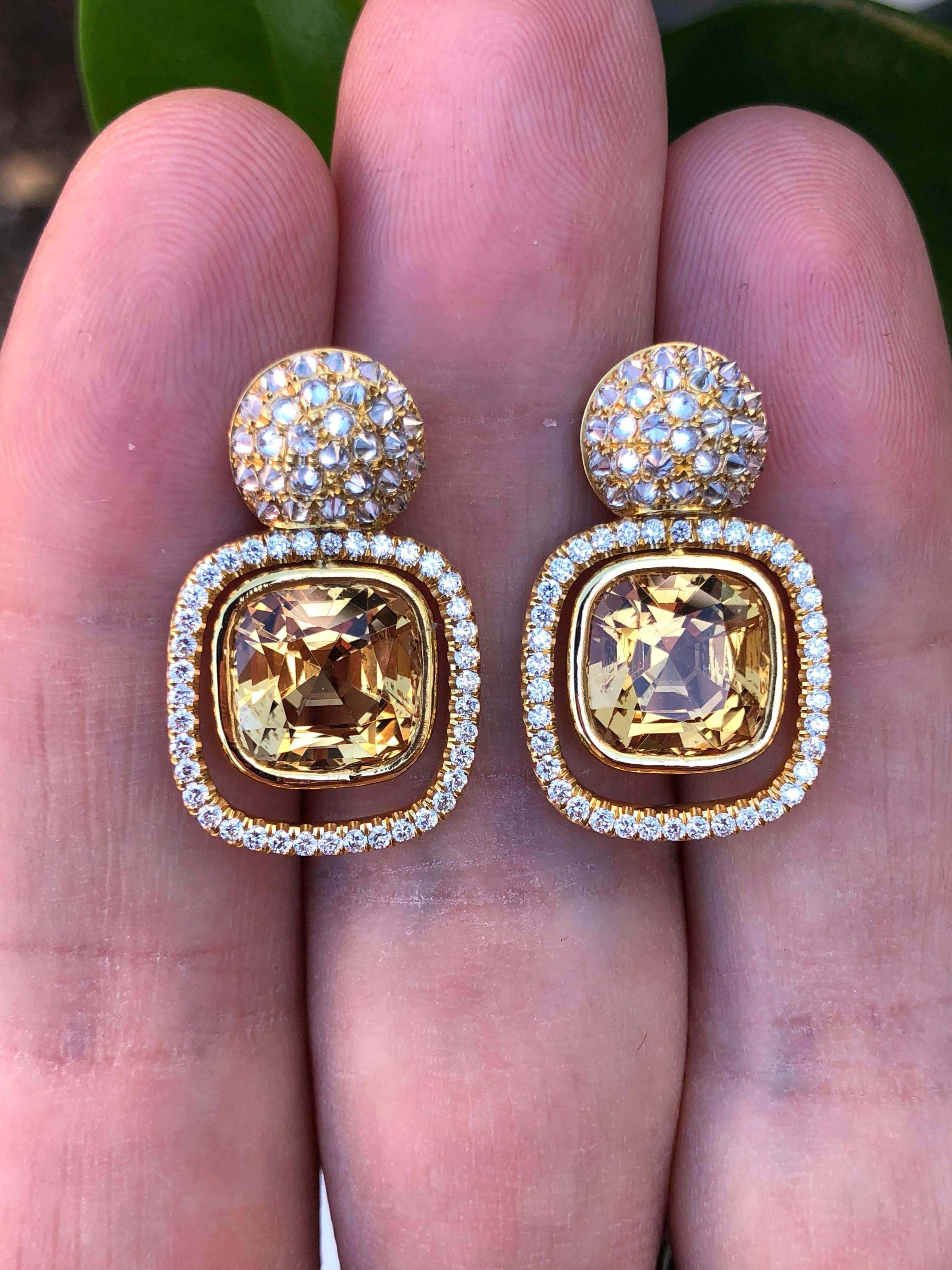 Natural Brazilian Imperial Yellow Topaz earrings, showcasing a superb pair of cushion cuts, 8.81 carats total, suspended from inversely -set, 1.63 carat total, round brilliant diamond earrings studs. 
Approximately 0.94 inches long and 0.59 inches