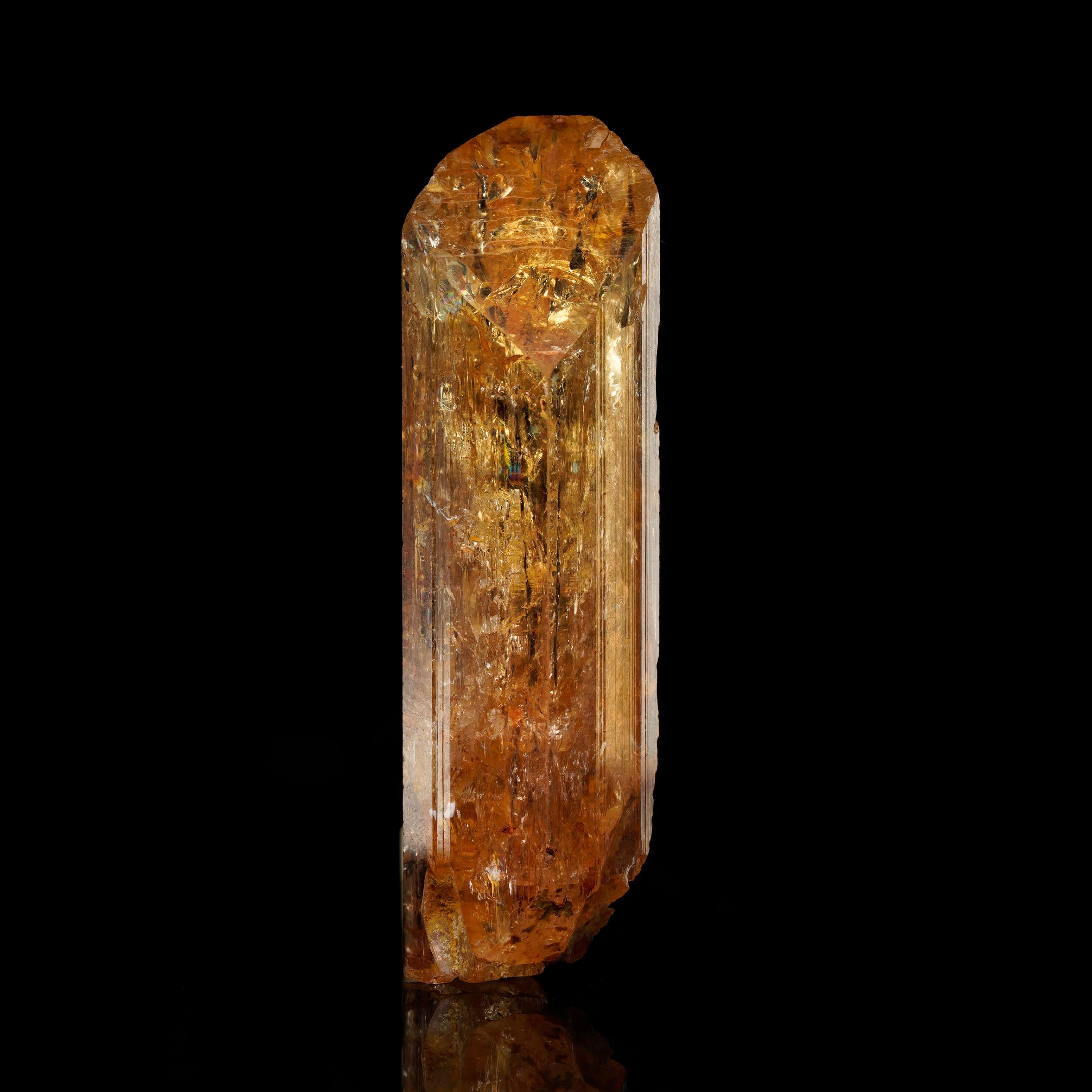This 11-gram Imperial Topaz from Zambia is a true gem featuring a radiant color and excellent clarity.

Key Features:
Dimensions: 3.81 cm height, 1.27 cm length, 1.27 cm depth
Large size
Brilliant golden color
Superior clarity
Ideal for high-end