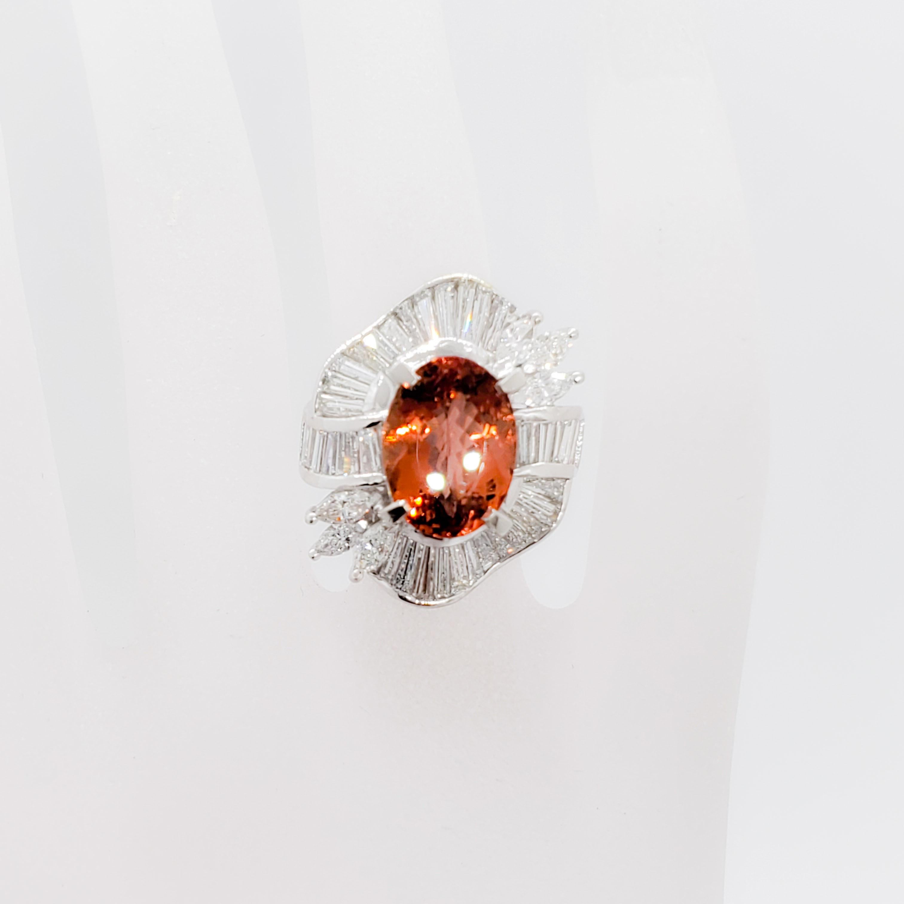 Absolutely spell bounding estate imperial topaz oval weighing 7.31 ct. with good quality white diamond marquise and baguettes weighing 2.82 ct.  Handmade platinum mounting in ring size 6.25.  The color on this stone is exquisite and the design is