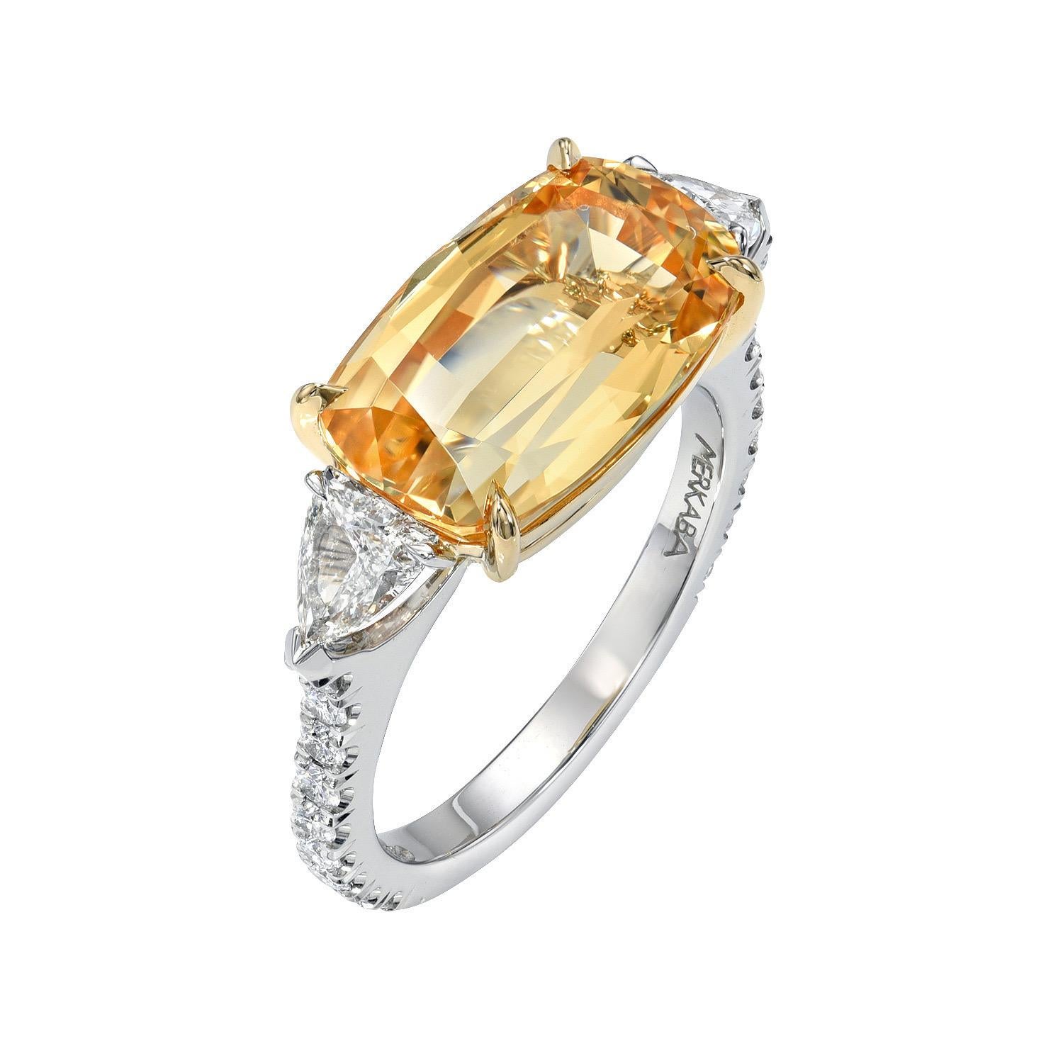 Sensational 6.59 carat Imperial Topaz, elongated cushion, platinum and 18K yellow gold ring, flanked by a pair of 0.57 carat, G/VS1, shield diamonds, and decorated with a total of 0.39 carat round brilliant collection diamonds.
Ring size 6.5.