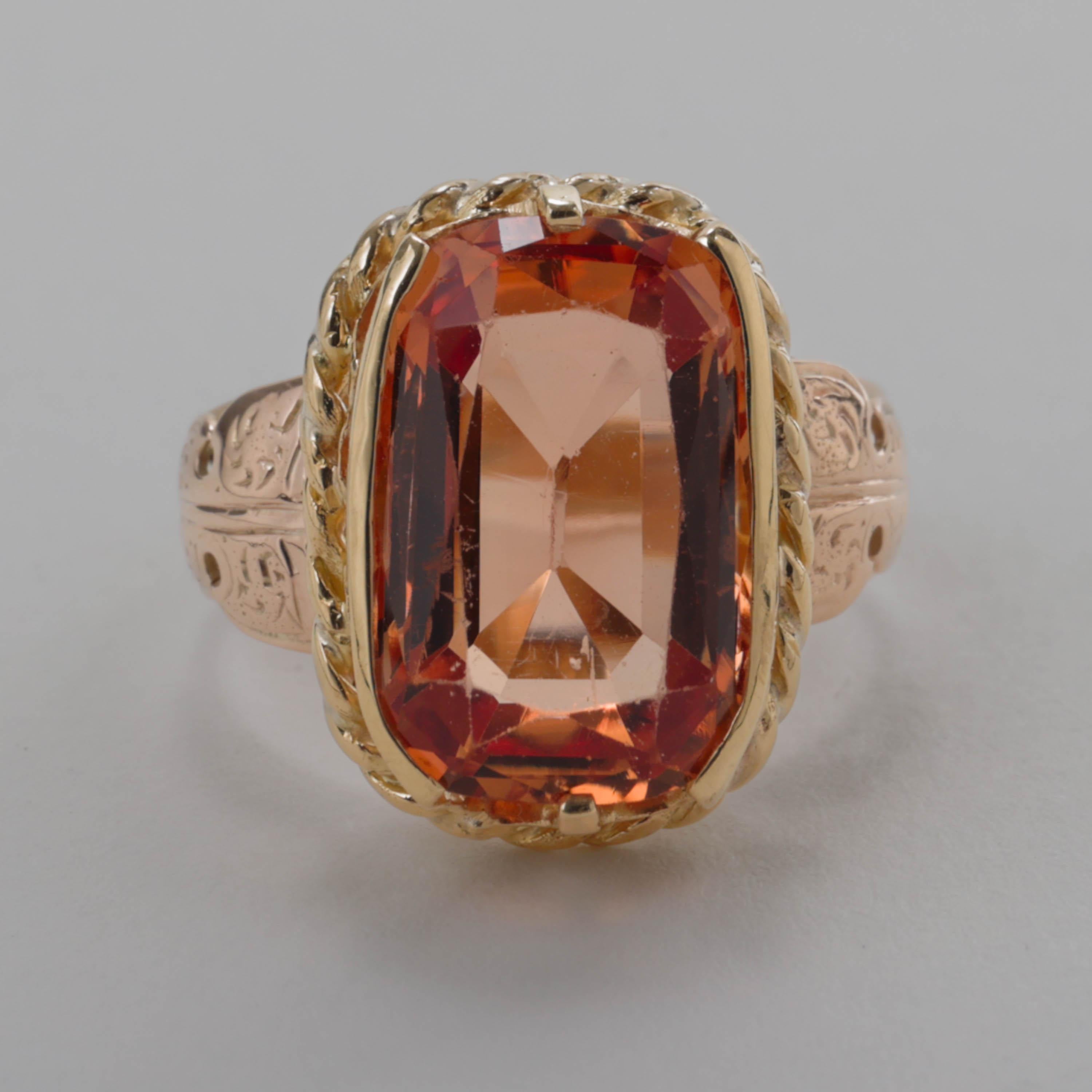 This is a genuinely impressive and rather spectacular ring. It features a large, cushion-cut reddish-orange imperial topaz that has been certified natural, untreated and with a Brazilian origin. The interesting thing about topaz is that it's