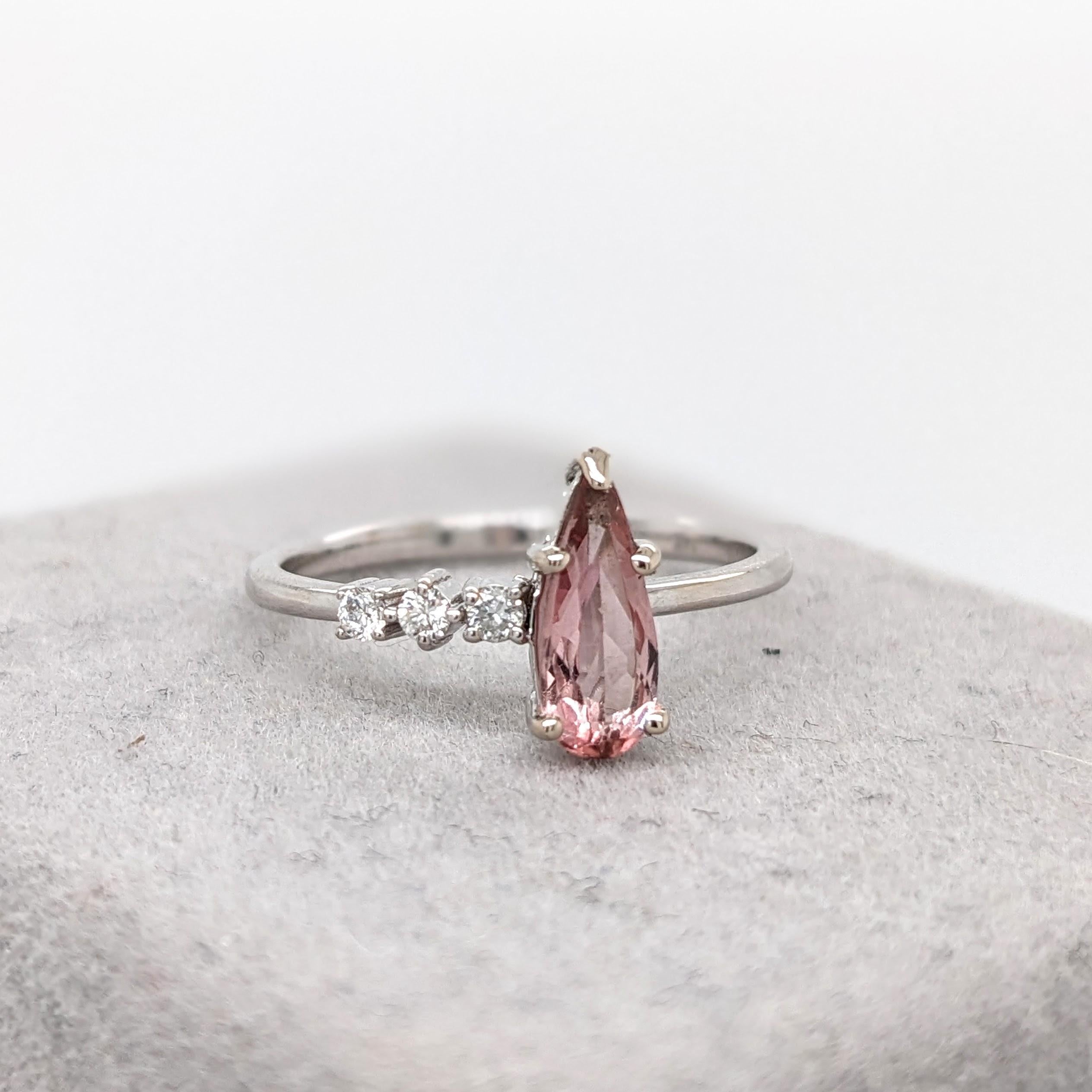 Imperial Topaz pear shaped stone mounted on a 14k white gold band with round natural diamond accents. This ring features a beautiful 0.68 ct blush colored imperial topaz, accented by natural earth mined diamonds and solid 14k white gold! This ring