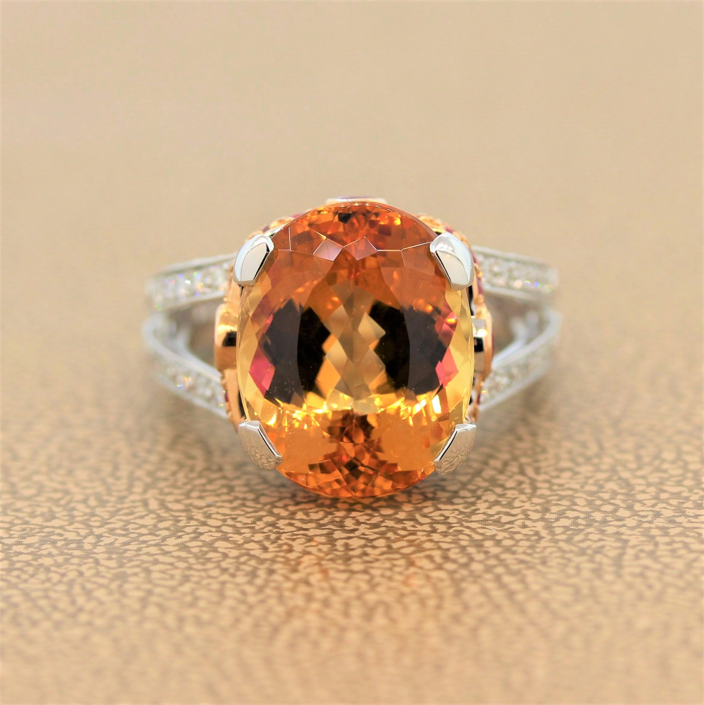 A perfect cocktail ring for day and night featuring a 12.70 carat imperial topaz in a platinum setting. The oval cut pinkish orange colored gemstone is adorned with a halo of 0.68 carats of round cut rubies in an 18K rose gold setting. The split