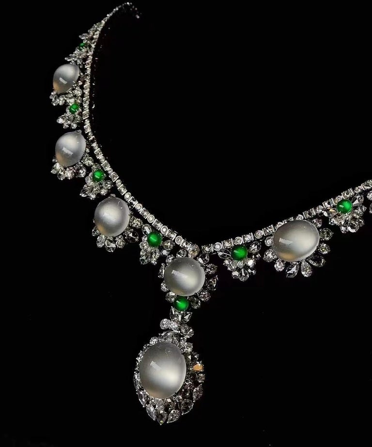 This Magnificent Necklace is composed of eight pieces of high quality translucent white jadeite cabochon and nine pieces of small imperial green cabochon, decorated with diamonds weighing 12.48 carats in total, mounted in 18K white gold. 
The