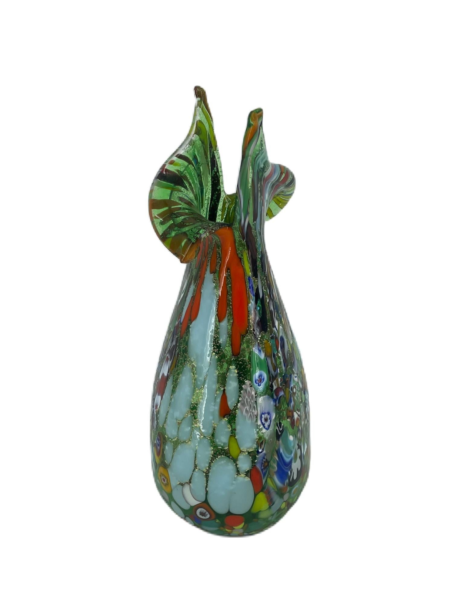 Vase from the ‘Fantasy’ collection in green blown Murano glass with assorted decoration of multicolour ‘Mace’ glass, Murrina Millefiori and silver leaf.
The vase has been hand-crafted by Murano master glassmaker Imperio Rossi.
Original Murano