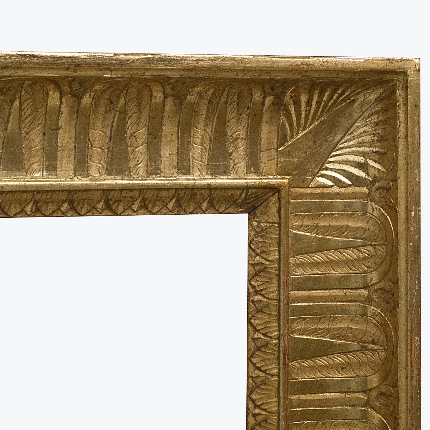 A spectacular frame mirror made in the Neapolitan decorative tradition, this piece exudes a bold and timeless historical charm that will be a singular addition to both classic and modern interiors. Superbly crafted and carved by hand, its wooden