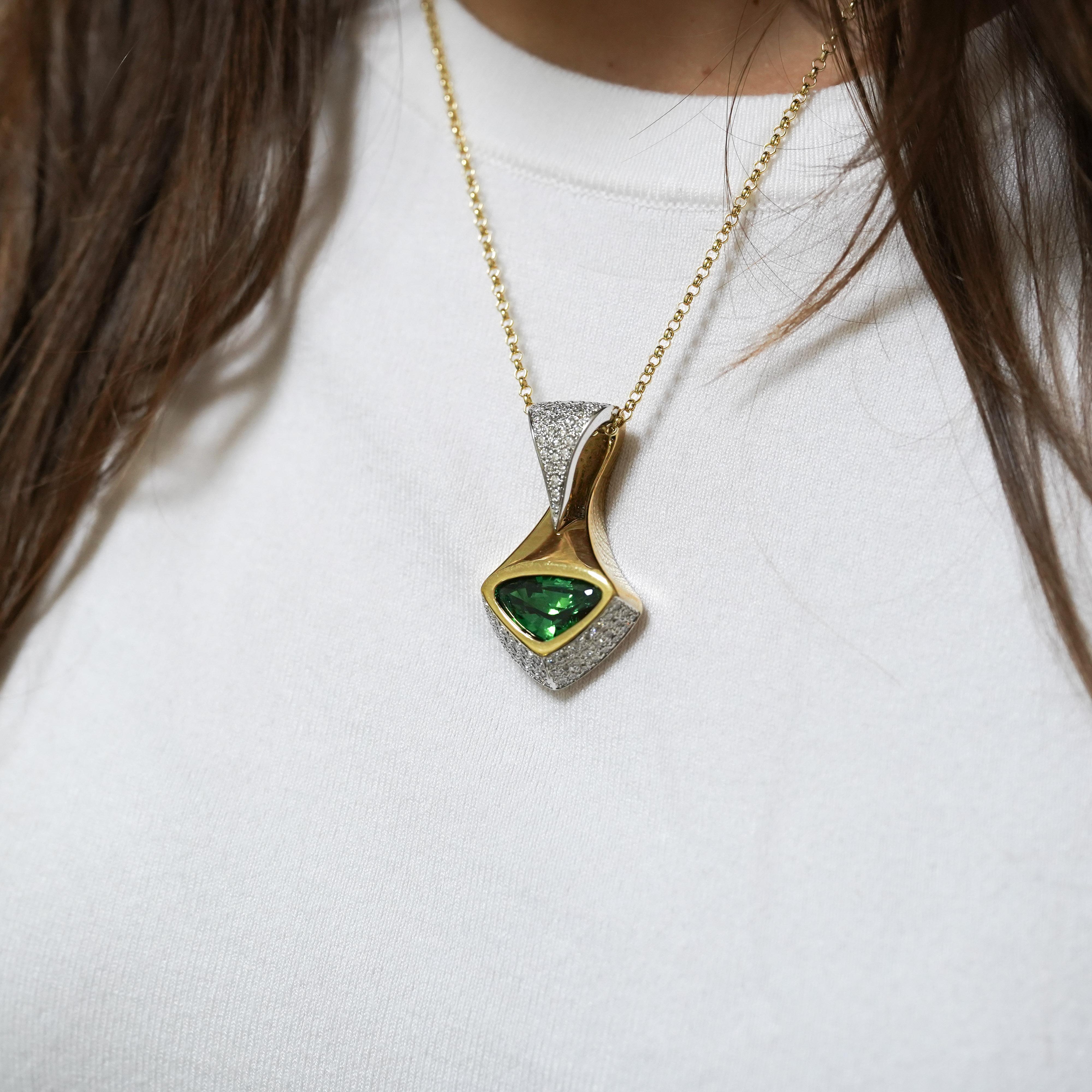 An exceptional GIA Certified 11-carat triangle-cut Tsavorite, a rare species of grossular garnet. This stone stands as one of the finest examples available on the market today. Featuring a remarkable vivid green hue, with intense saturation, yet