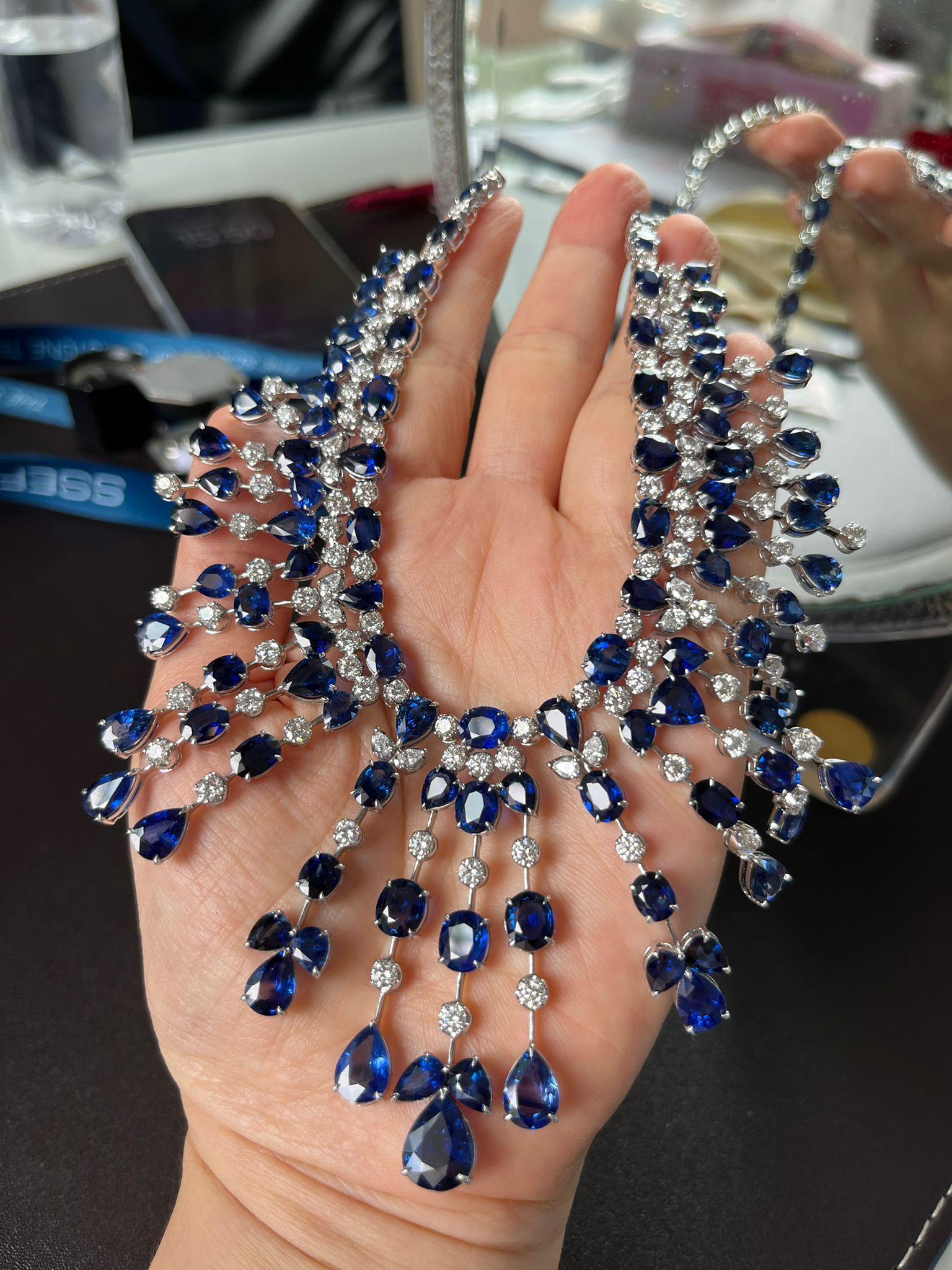 Experience the epitome of elegance with our exquisite necklace featuring 108 carats of natural royal blue Ceylon sapphires, renowned for their vivid blue hue. Complemented by 13 carats of natural diamonds, this masterpiece is set in luxurious 18k