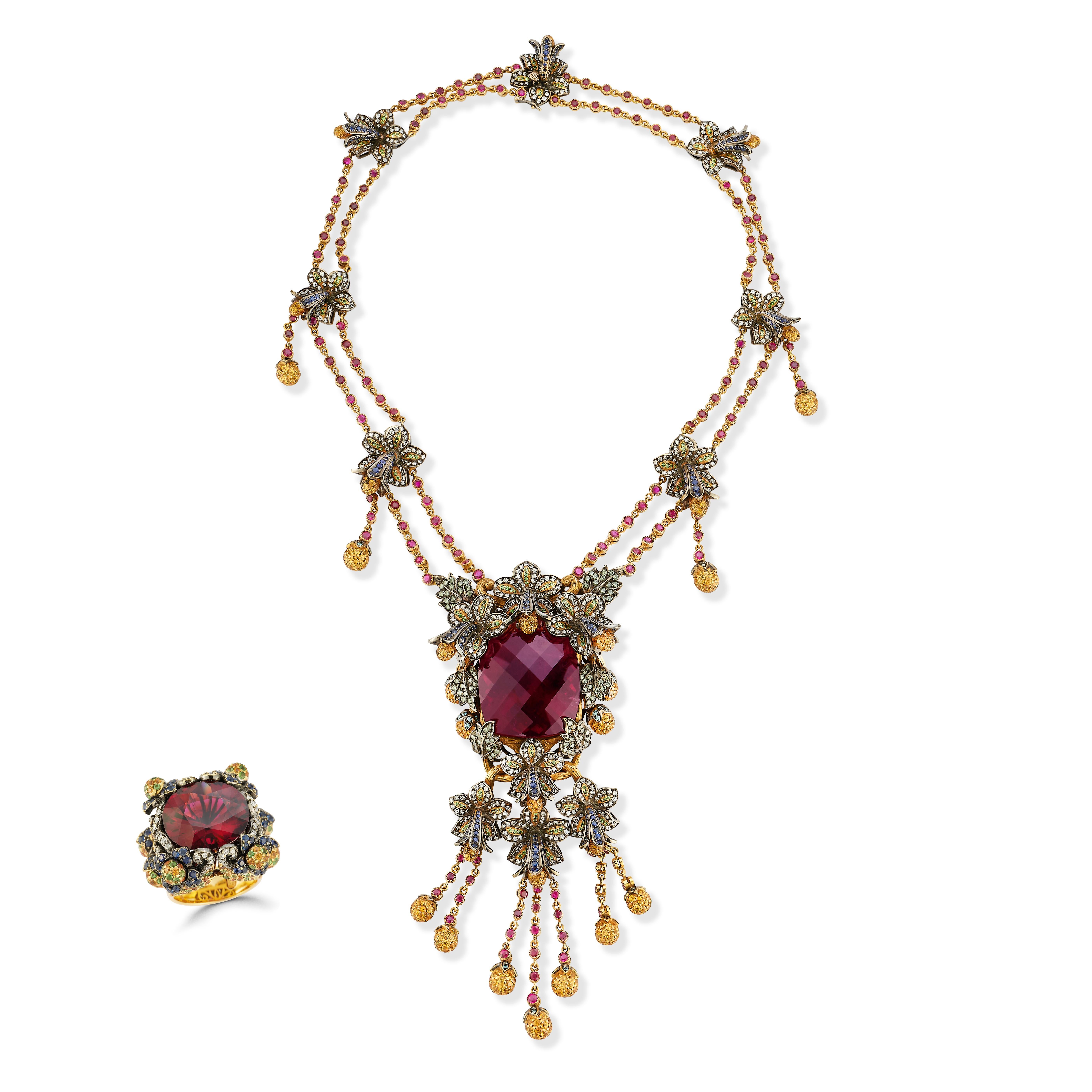 Important 125 Carat Rubellite Necklace And Ring Set 

This beautiful set has a necklace featuring a important center cushion cut rubellite tourmaline weighing approximately 125 carats surrounded by pave multi gems, diamond flower motifs, a draping