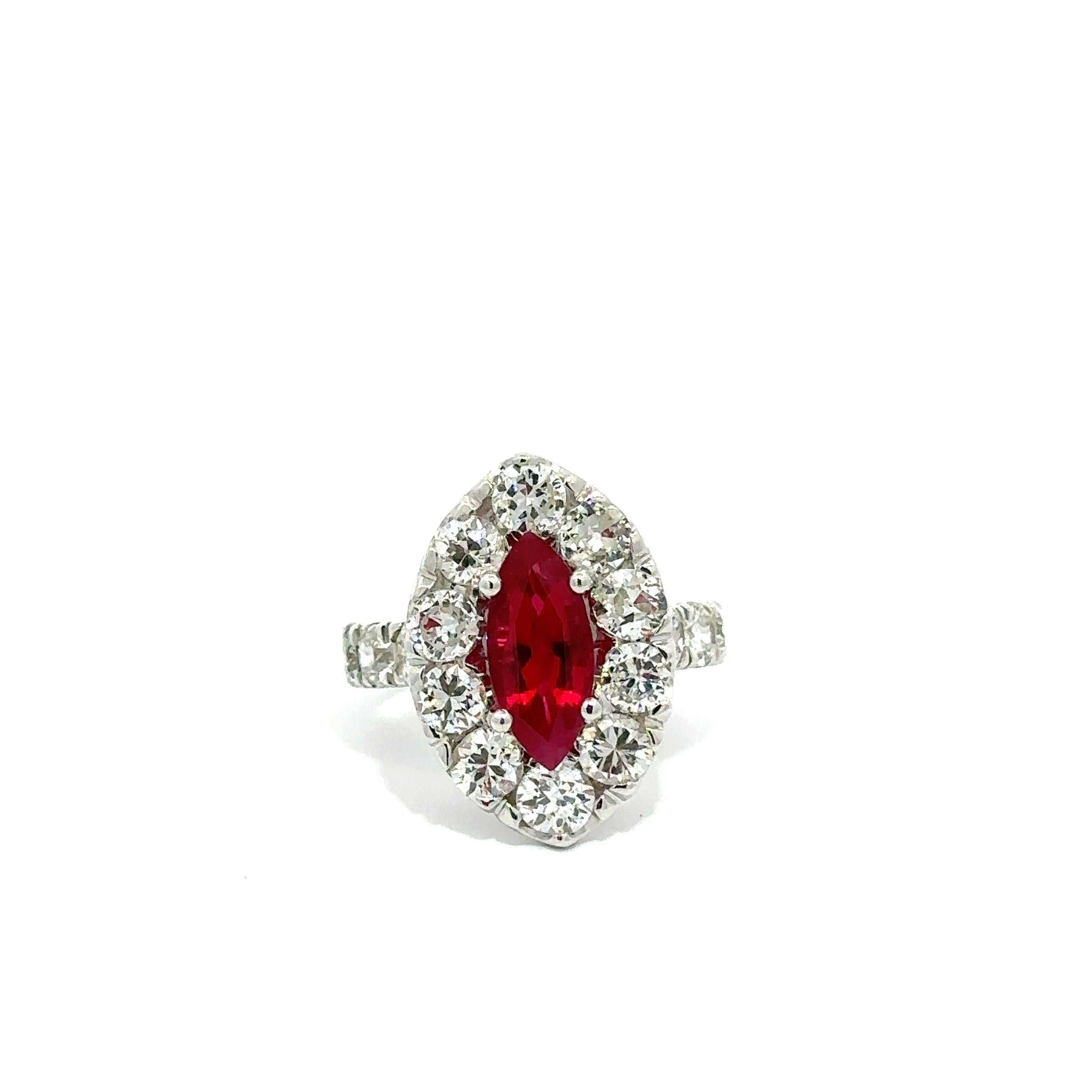 This large and dramatic cocktail ring features a Burma originated marquise cut ruby that has a fine and truly exceptional vivid red color. It is certified by both GIA and AGL as having only minor heating treatment and weighing 2.42 carats. The ring