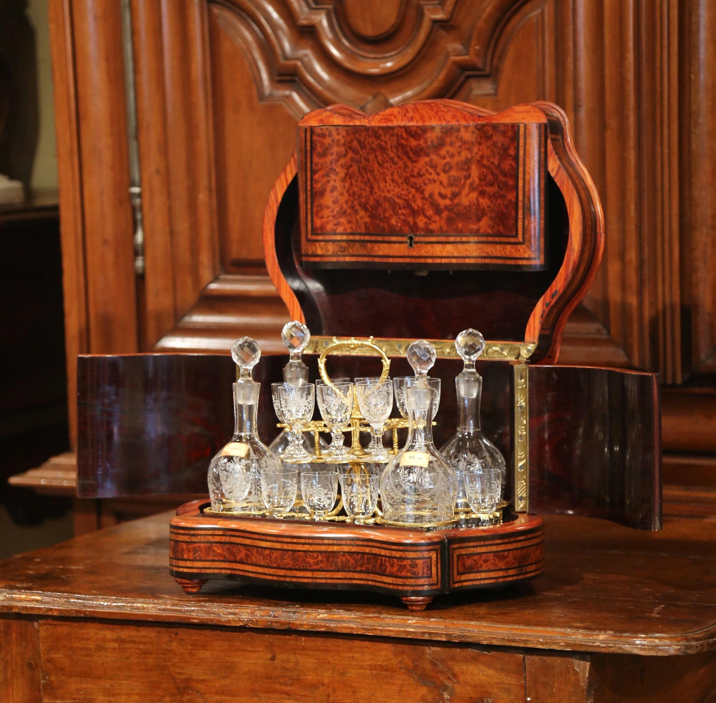 Create an elegant bar area with this antique and complete fruit wood liquor box from France, circa 1870. Bowed on the sides, the rectangular Tantalus sits on round carved feet and features an elegant top medallion with brass and marquetry motif,