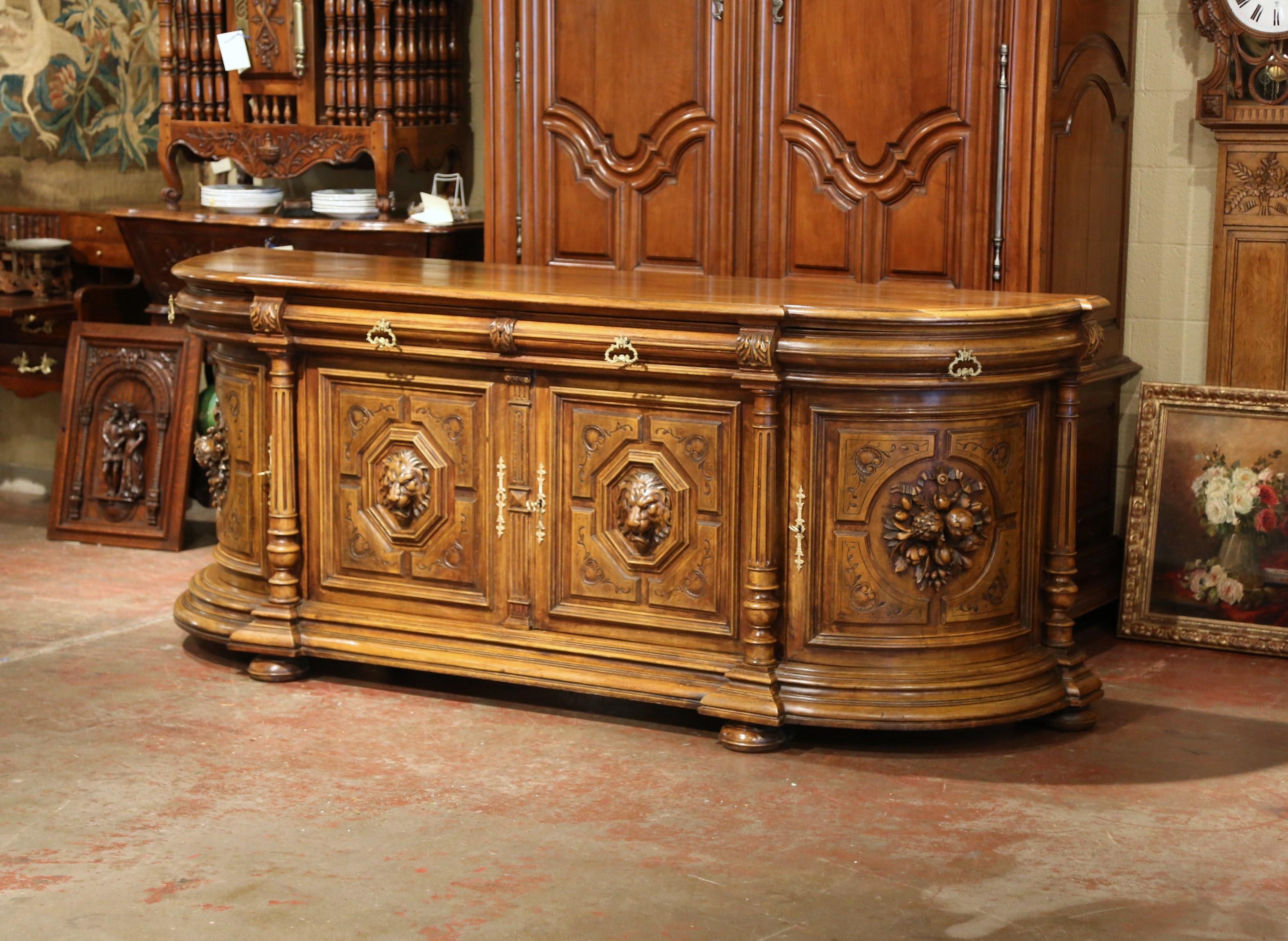 Add both surface and storage space in your dining room with this large buffet serving piece. Crafted in France circa 1860, the long, fruitwood cabinet sits on bun feet and features four doors and four drawers with decorative brass pulls. The piece
