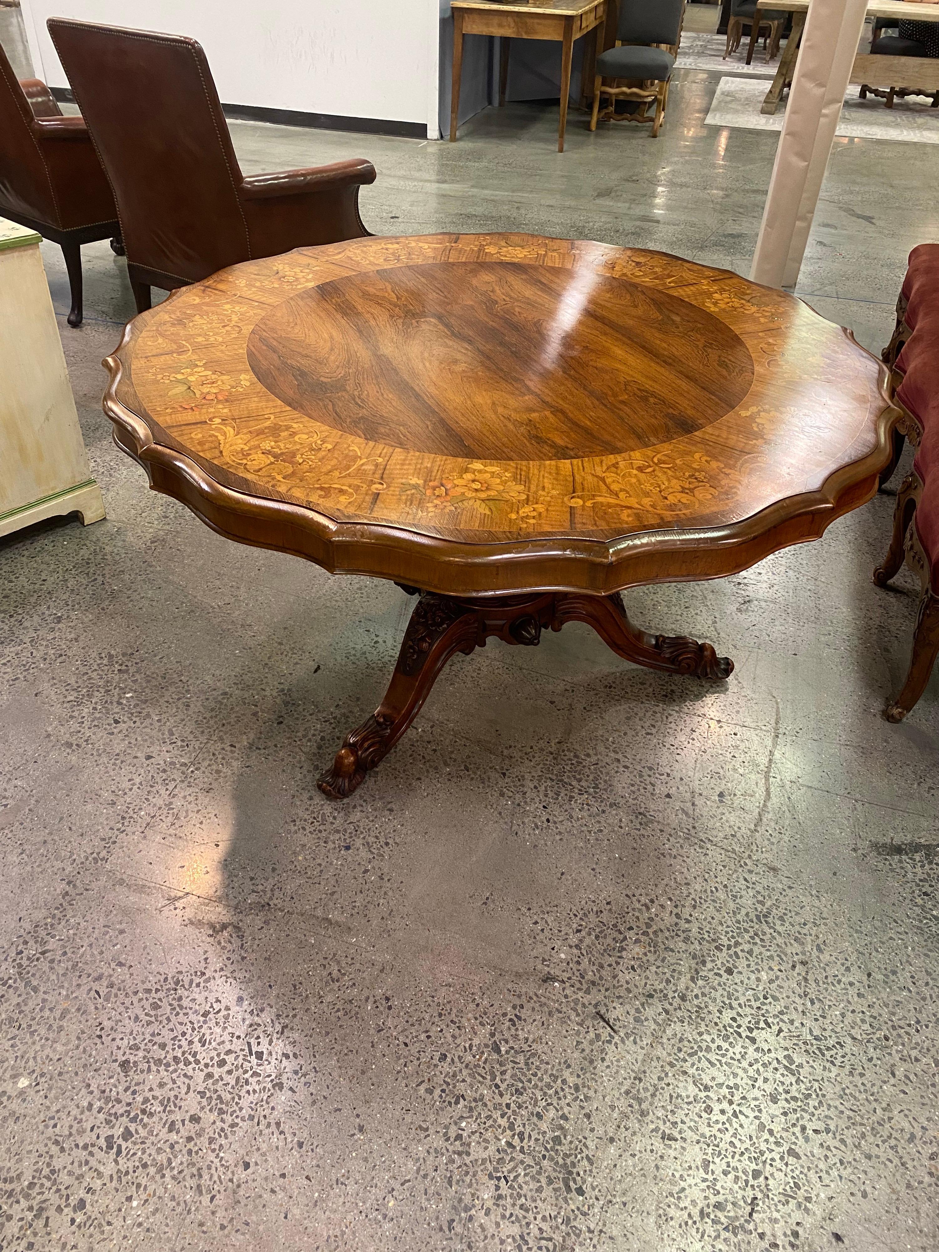 Exceptional and important singed 19th century signed Irish rosewood center table with polychrome floral marquetry inlay. Beautifully carved pedestal base. Top is shaped and inlaid with crossbanding and red and green stained marquetry floral inlay.
