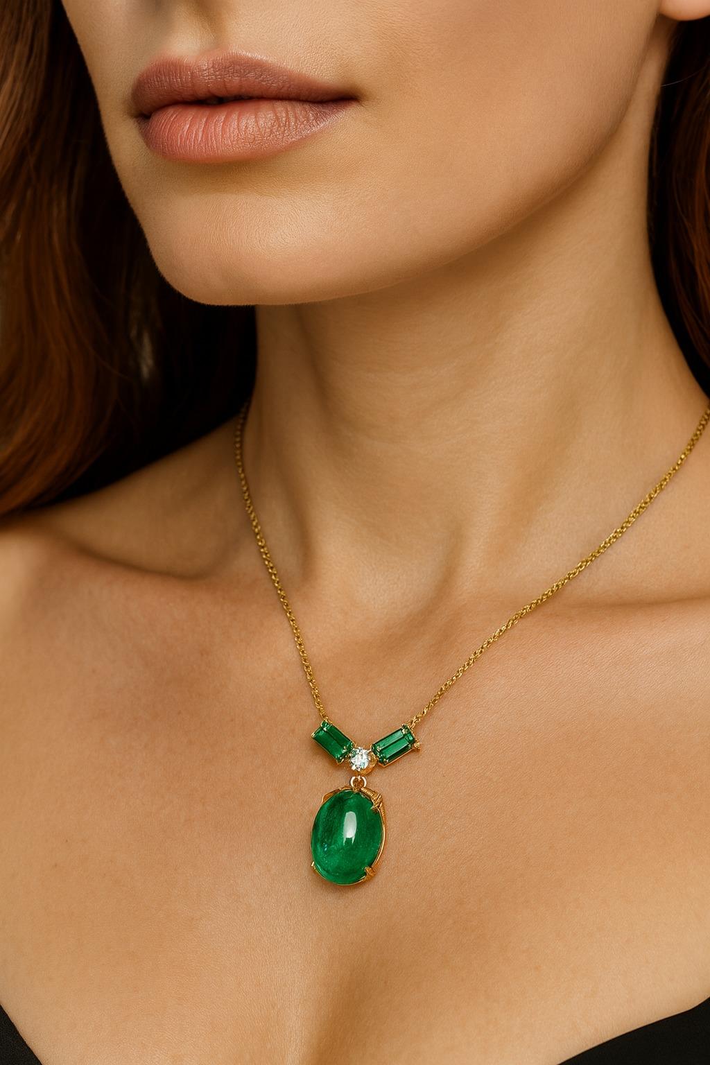 A remarkable custom-made pendant necklace crafted in solid 18K yellow gold, showcasing an important cabochon emerald of approximately 18.00 carats. The emerald displays an intense vivid green color, with rich saturation and excellent