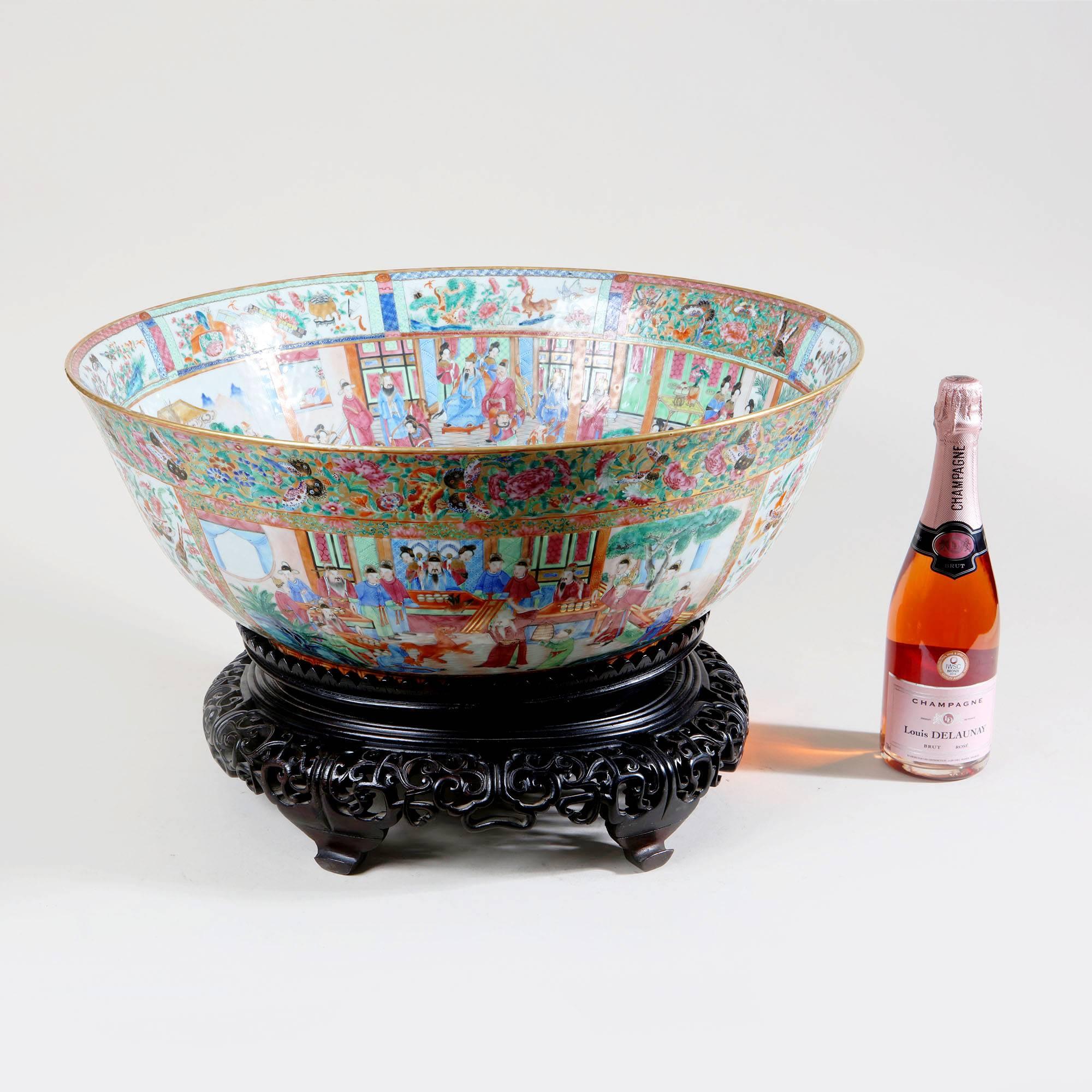 An extremely rare 19th century Canton porcelain punch bowl decorated in famille rose with panels of scenes of Chinese courtiers richly enamelled with gold-ground borders with butterflies, flowers, fruit and auspicious objects and gilt