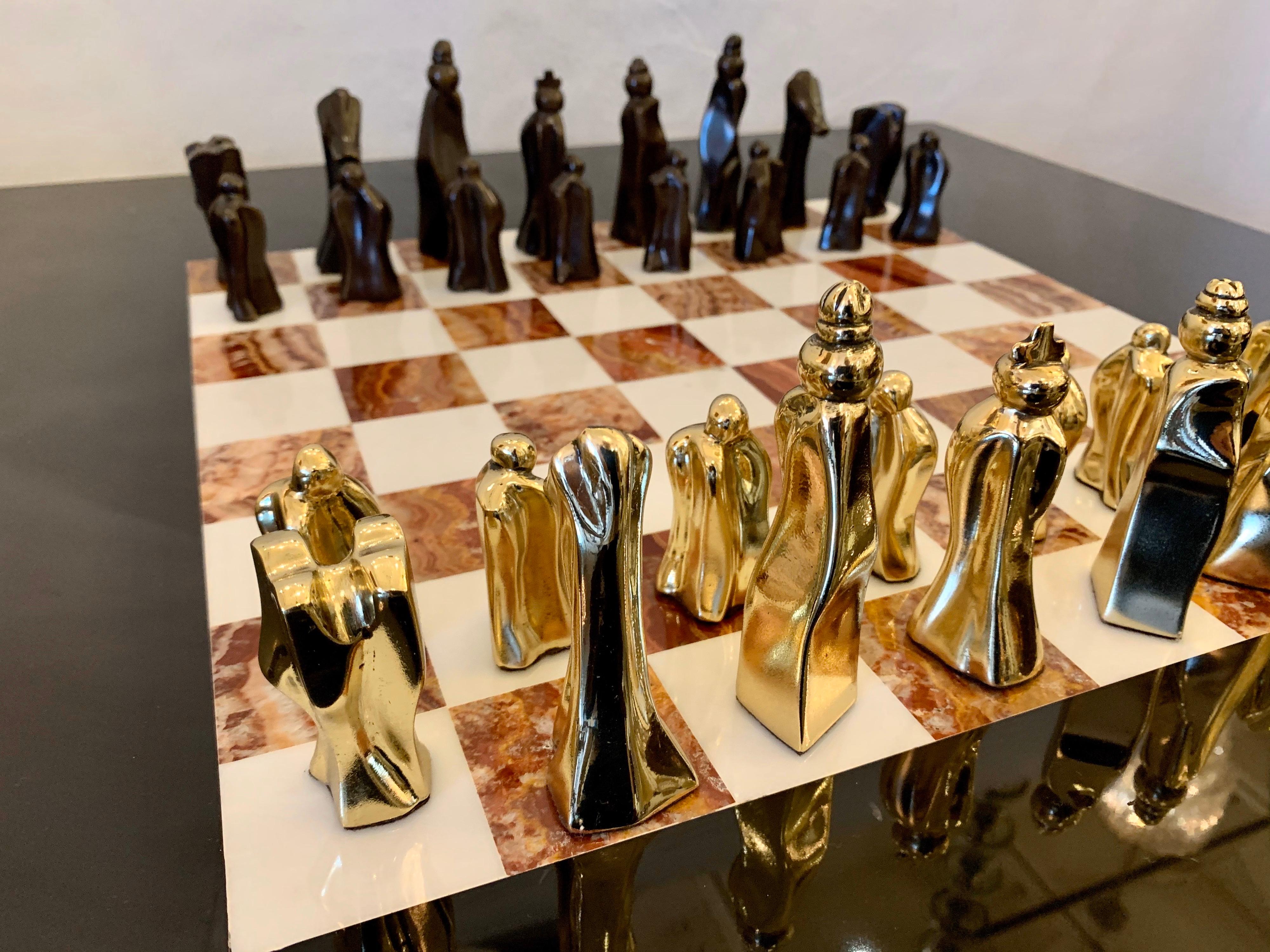 This is a low chess table/ coffee table height with the most original and rare chess pieces. All bronze in polished and dark patina finish (32 pieces). The marble top, is a rare Belgian deep black stone, free from any veins or patterns.