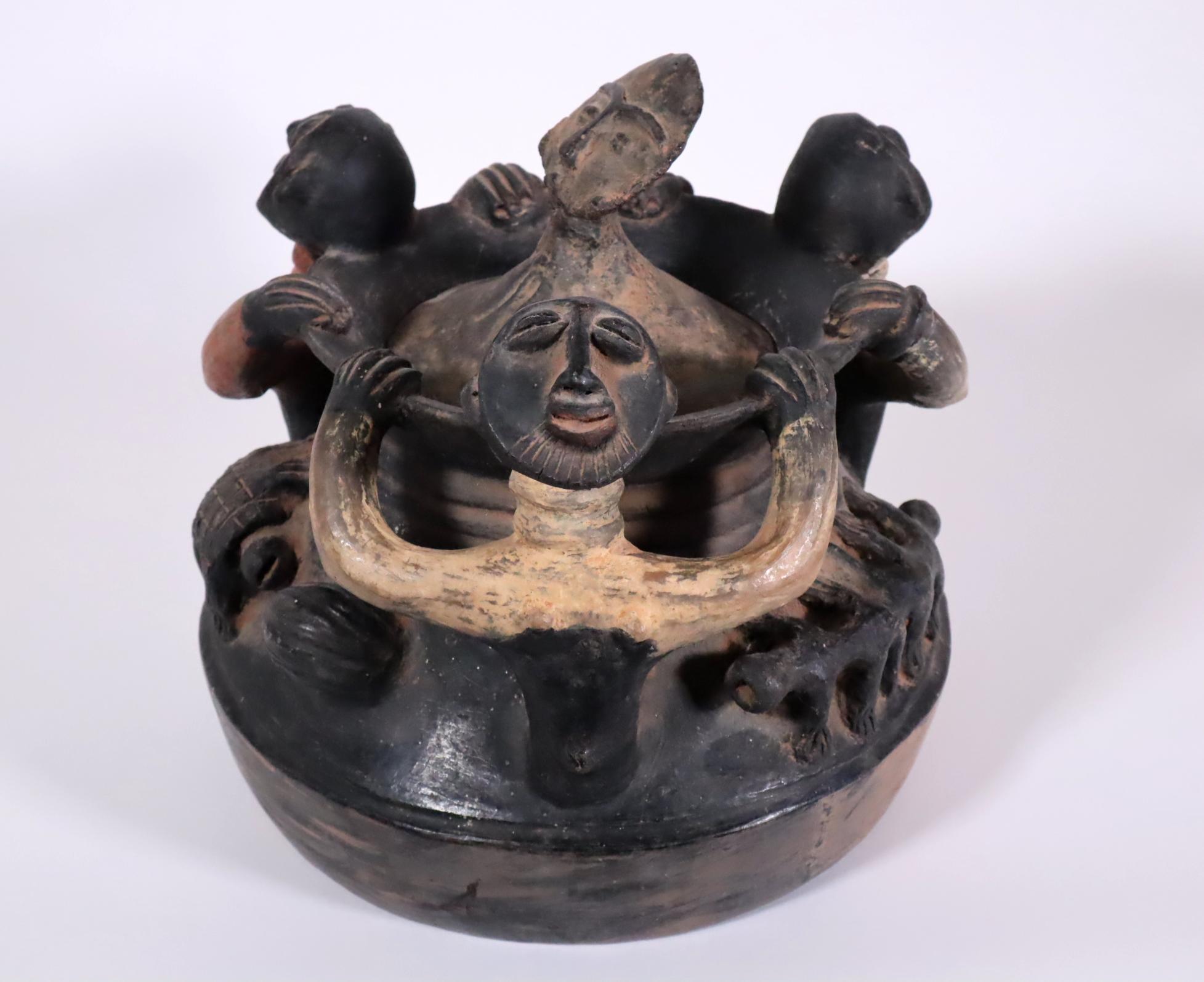Store closing March 31. Last chance clearance sale.  A colorful and delightful large ceramic treasure vessel from the Akan people of Ghana. Earthenware with black, orange, red, and cream colored paint, early 20th century.
Rising from the shoulder of
