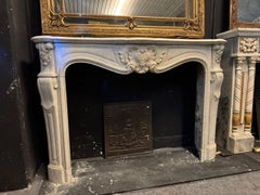 Important and beautiful fireplace mantel in carved white Carrara marble, France