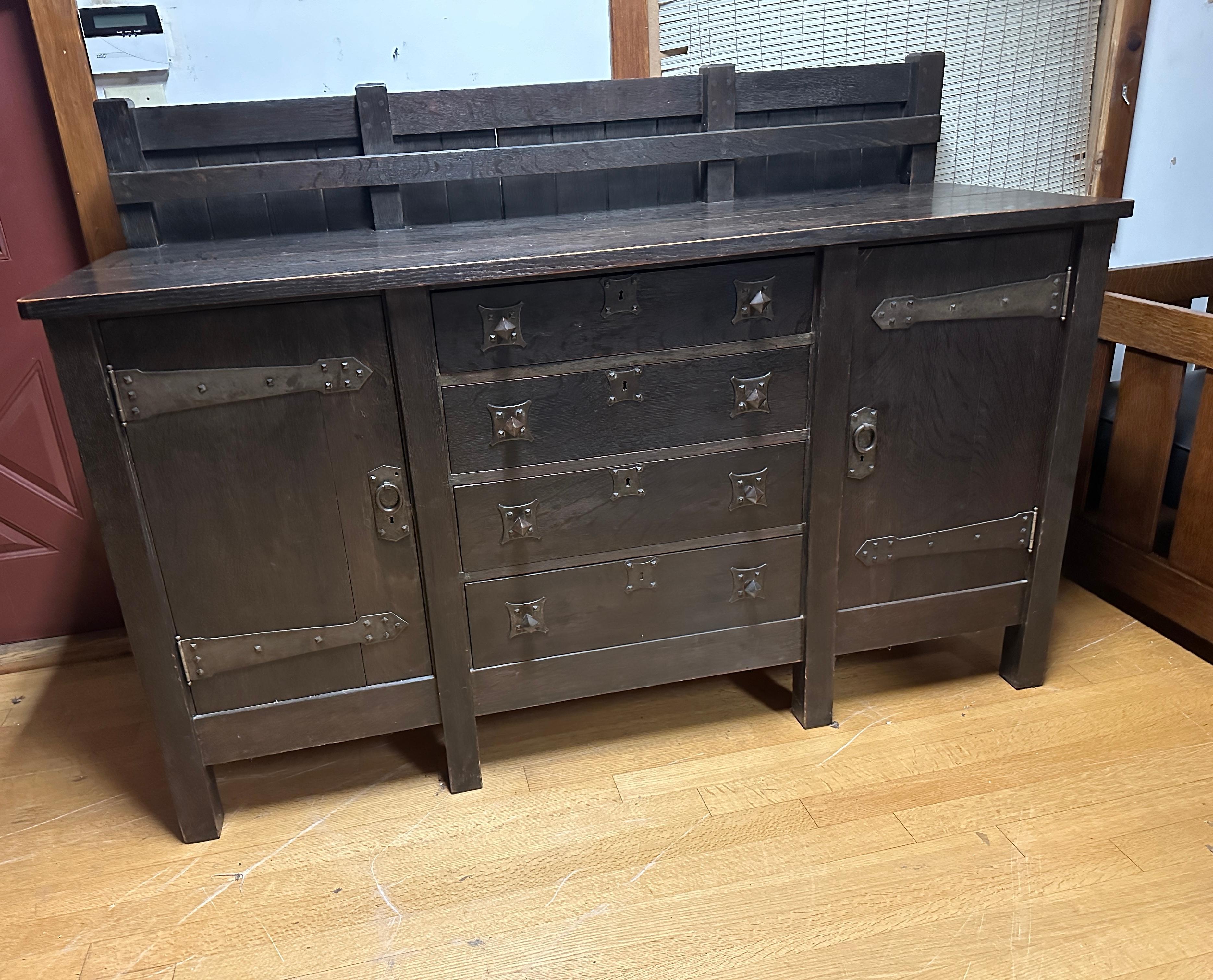 This is an important Gustav Stickley 8-Leg Sideboard from 1901 in Excellent Condition with great strap hinge hardware & pull hardware that you don't often see. 

Gustav made this model at the beginning of his work.  There are very few examples of