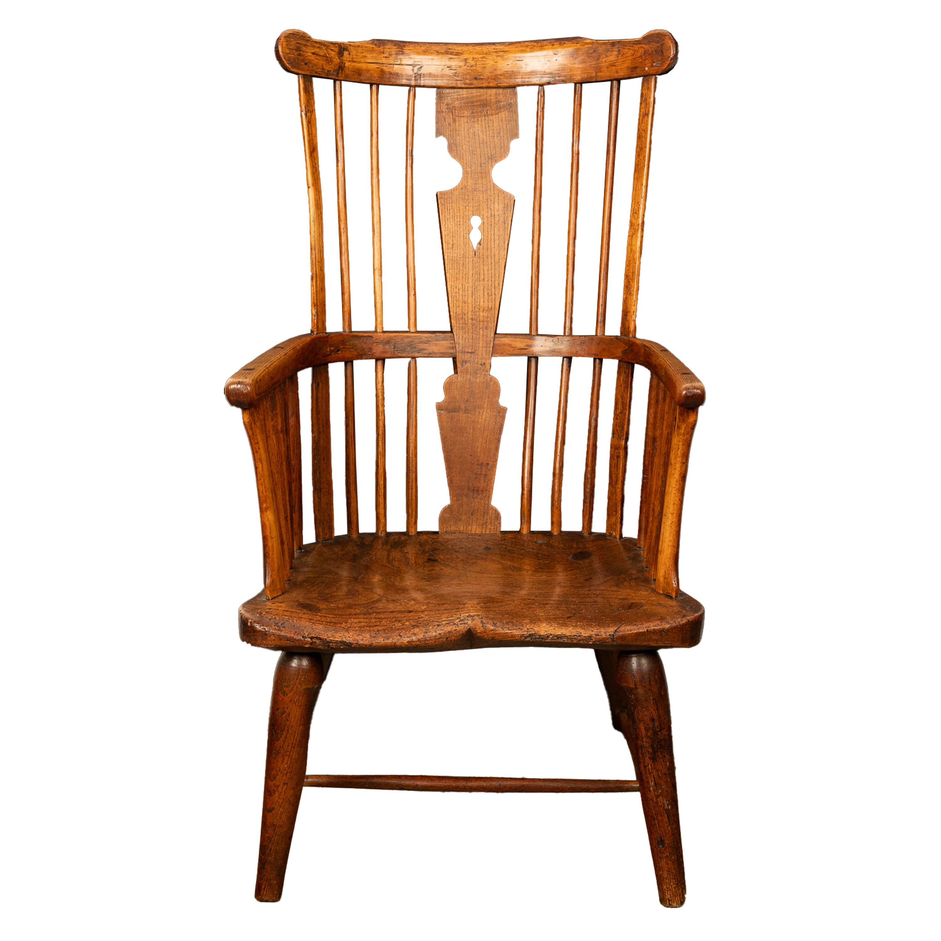 An important antique earliest documented Windsor chair by Kerry of Evesham, 1793.
The high comb back chair is made from ash & elm, the spindled back with a shaped top splat, to the center of the chair is a pierced 'keyhole' shape, the chair has a
