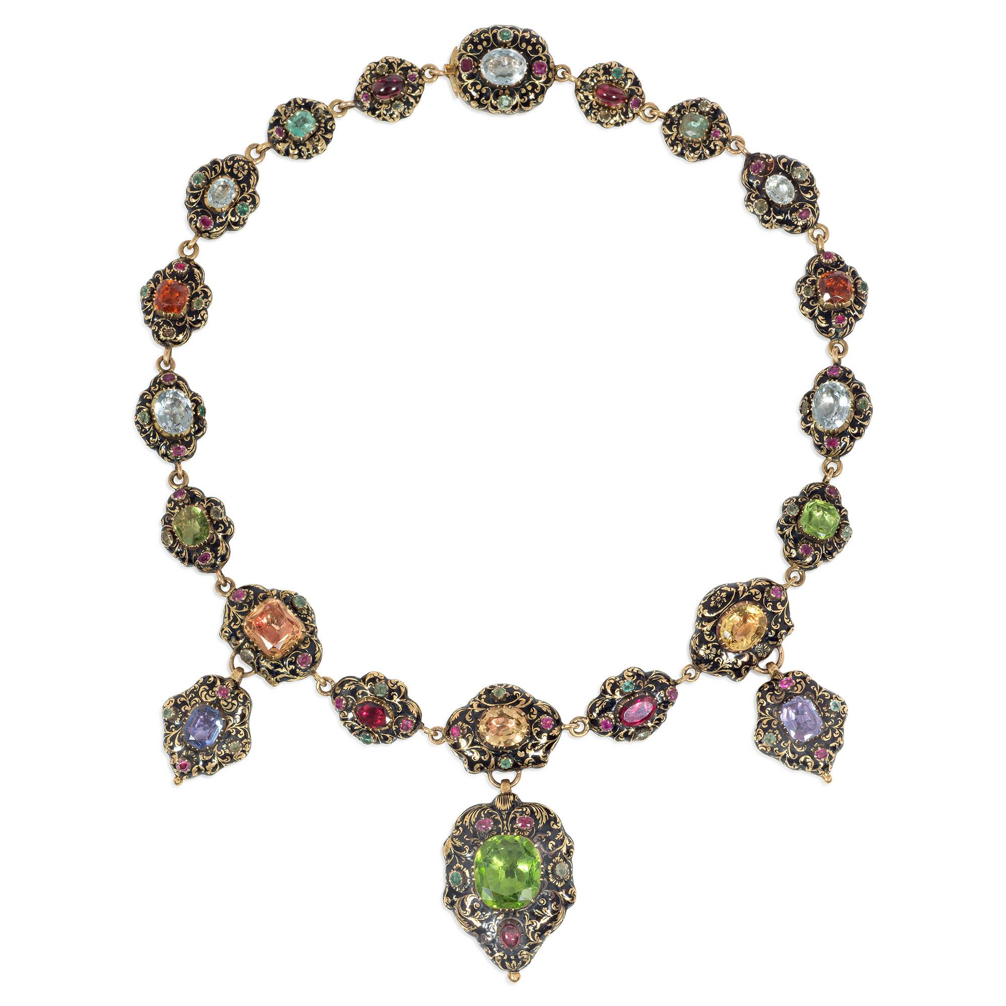 A highly important Georgian Swiss enamel, gold, and multi-gemstone necklace with pendant elements, in 18k.  The elaborately decorated links are set with topaz, peridots, garnets, sapphires, emeralds, and rubies and feature scrolled foliate patterns